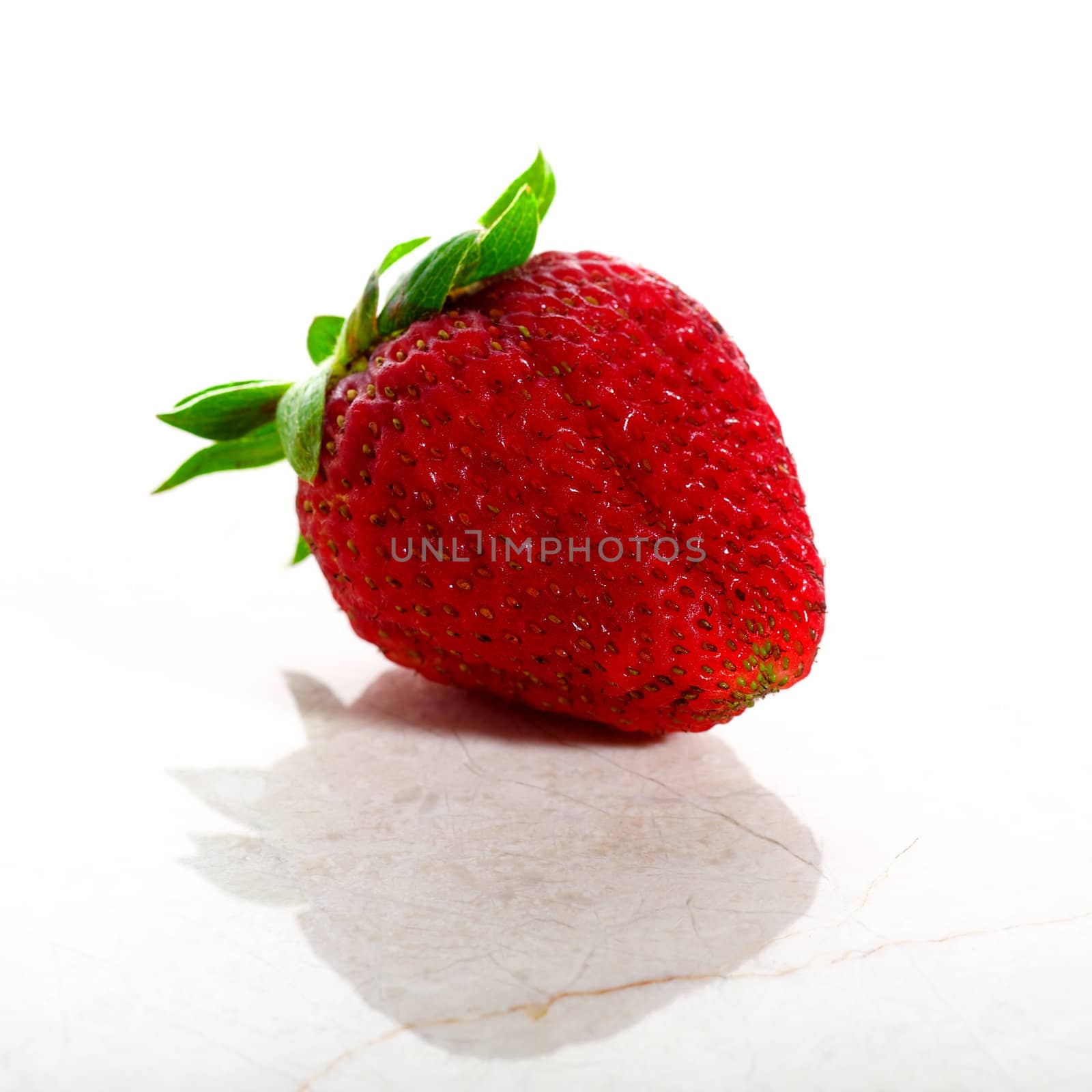 Delicious strawberry isolated on white with a marble base in high key