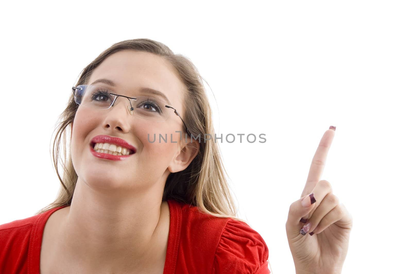 caucasian model smiling and pointing upwards against white background
