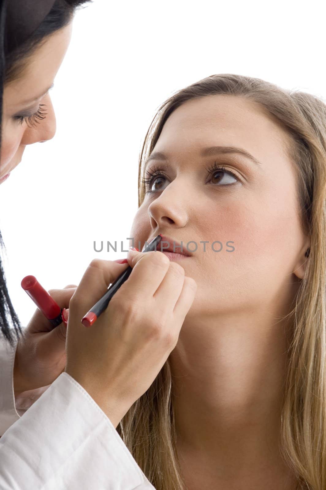 young pretty beautician applying lipstick with white background