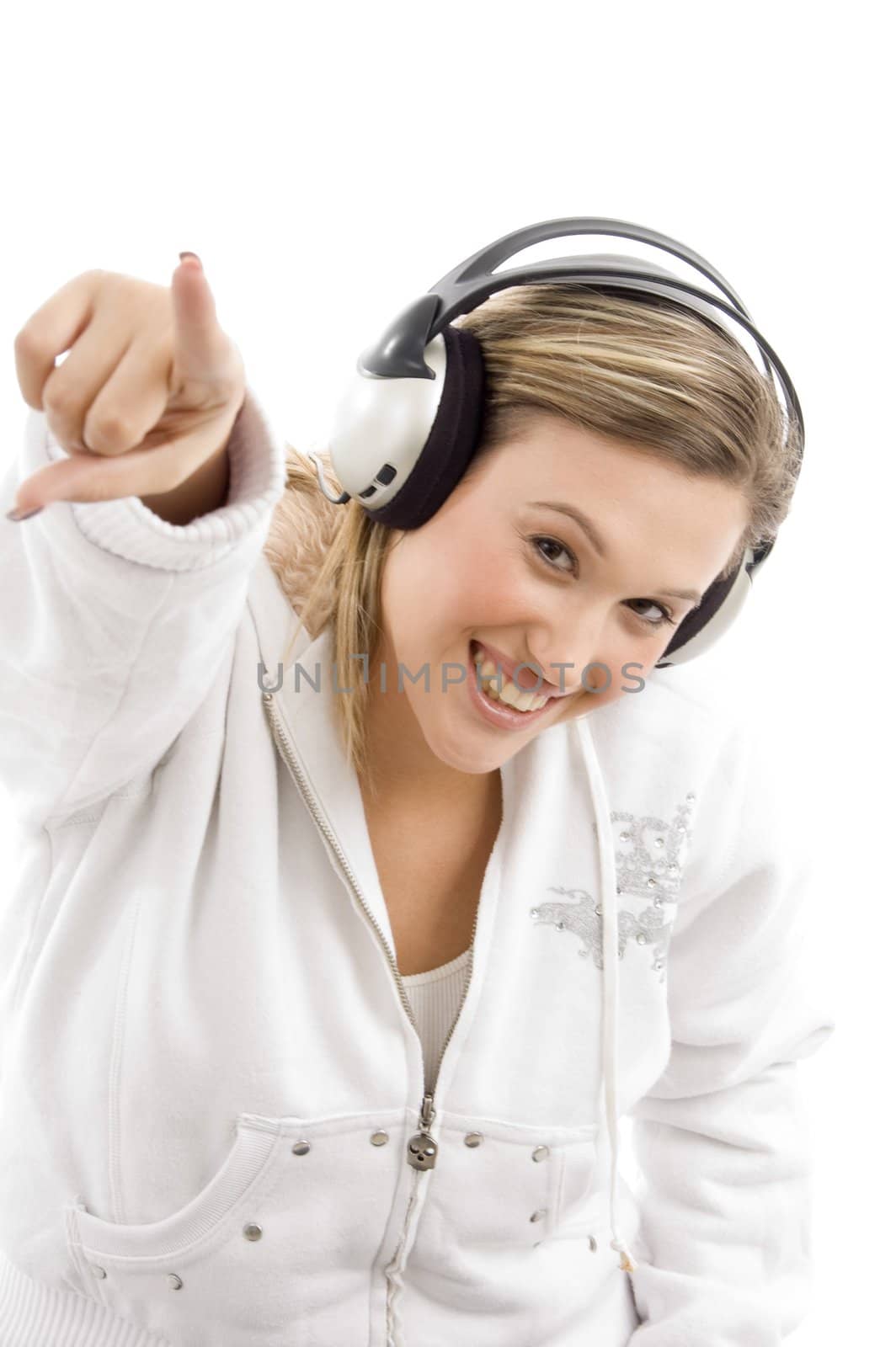 young female pointing in front of camera and wearing headphones by imagerymajestic