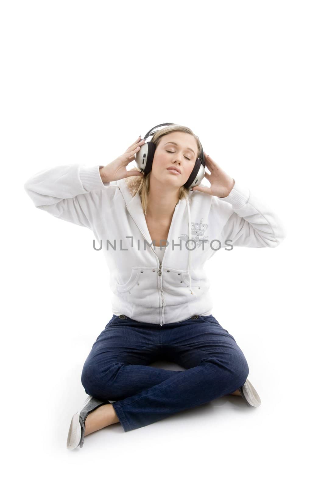 young model listening music with headphones against white background