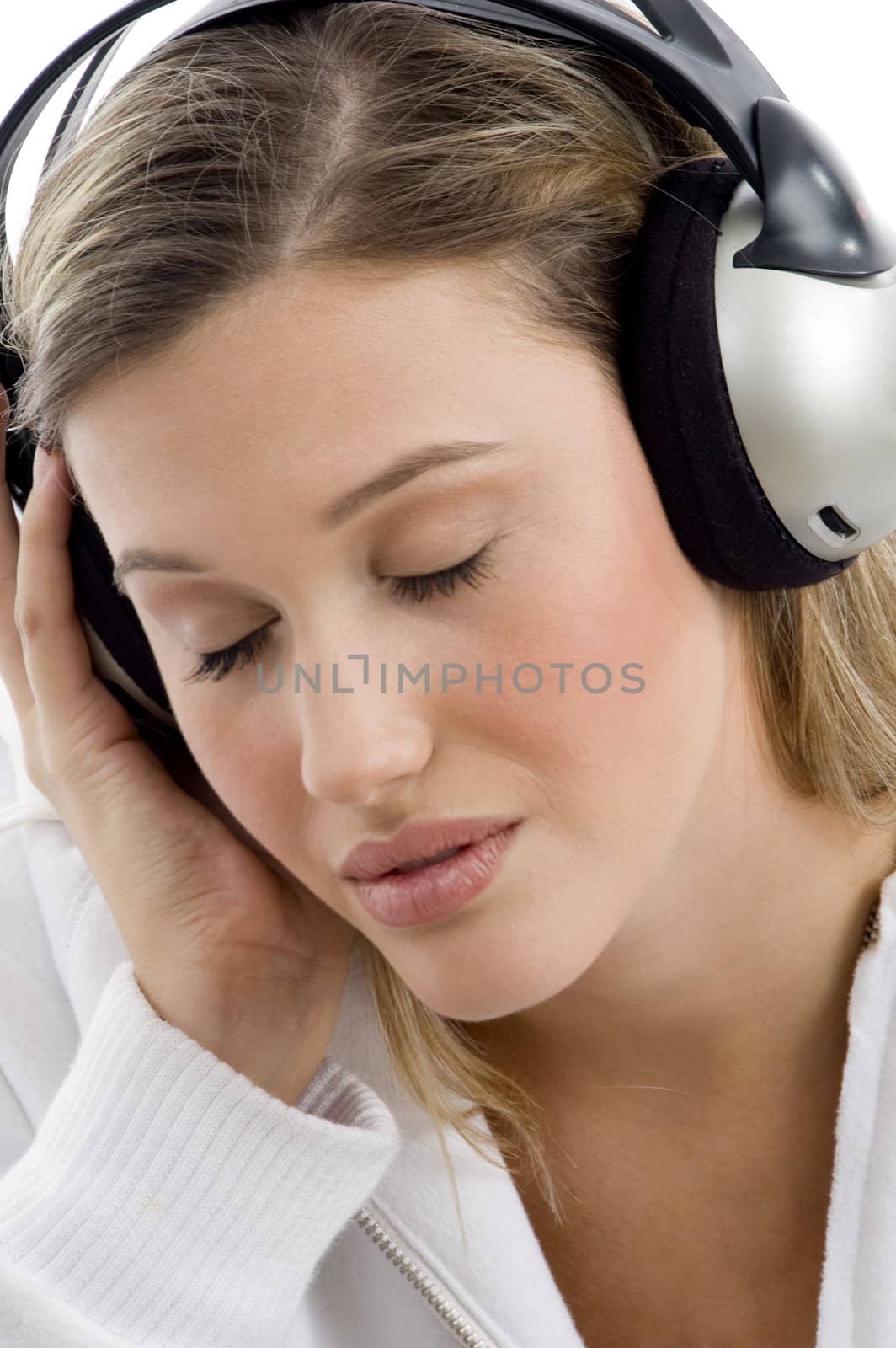 woman listening to music with closed eyes on an isolated white background