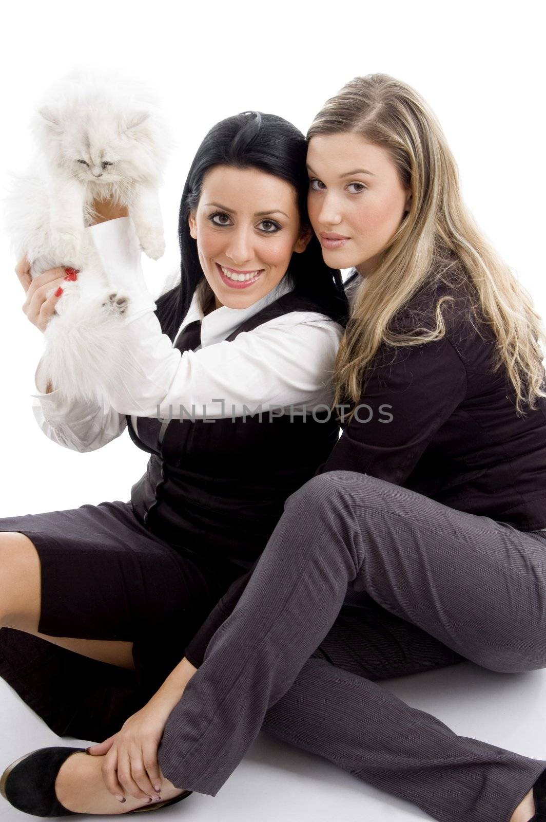 young woman holding her pet cat and looking at camera by imagerymajestic