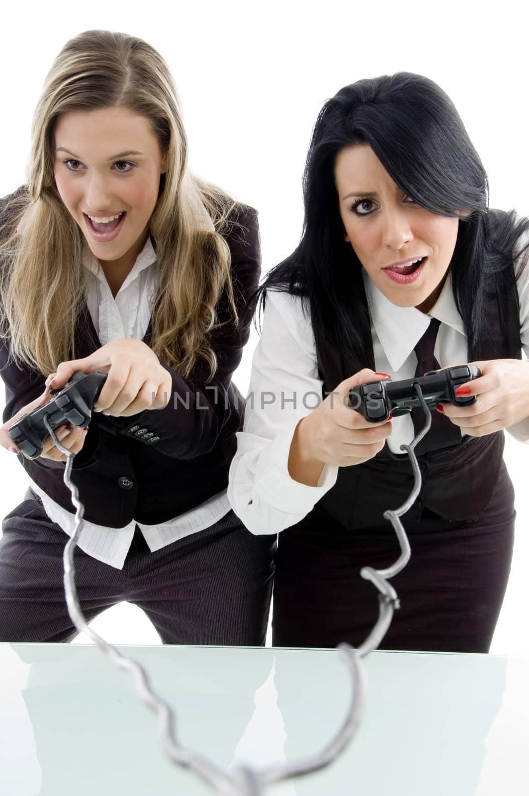 female partners playing game and holding remote by imagerymajestic
