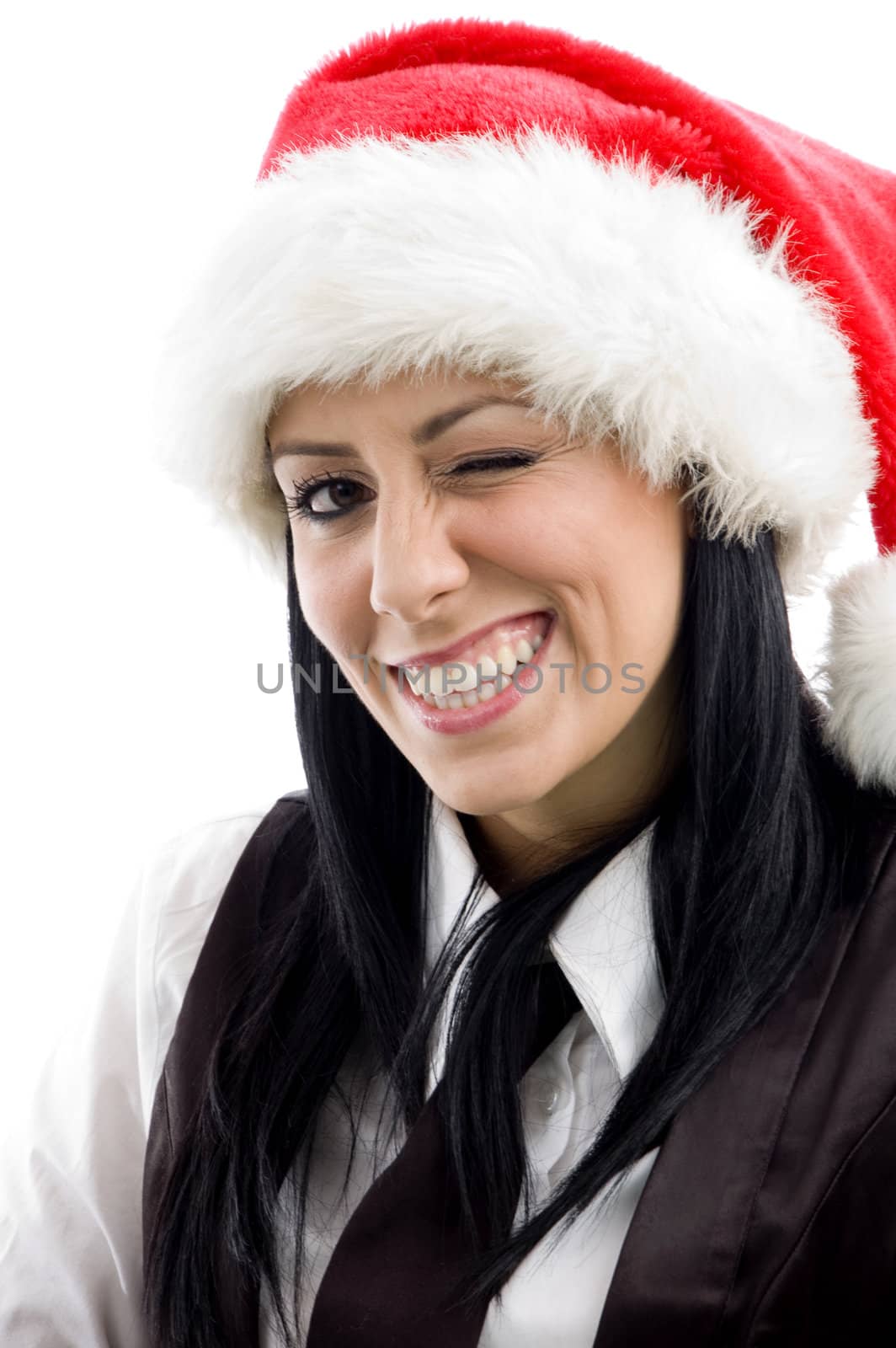 young female winking eyes and wearing christmas hat against white background