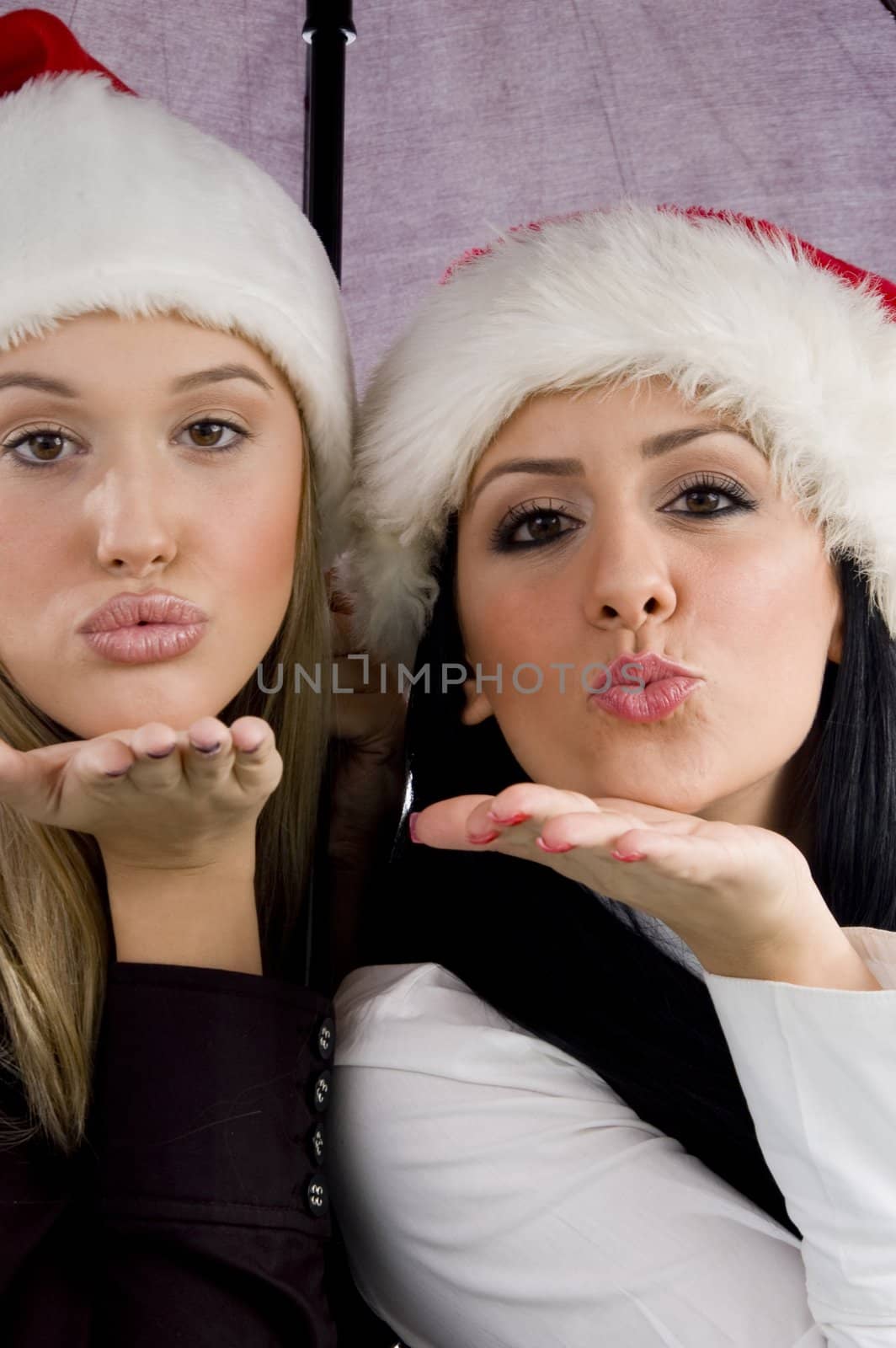 women giving christmas kiss with white background
