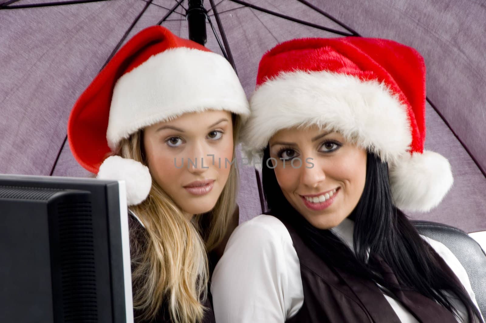 young colleagues wearing christmas hat on an isolated background
