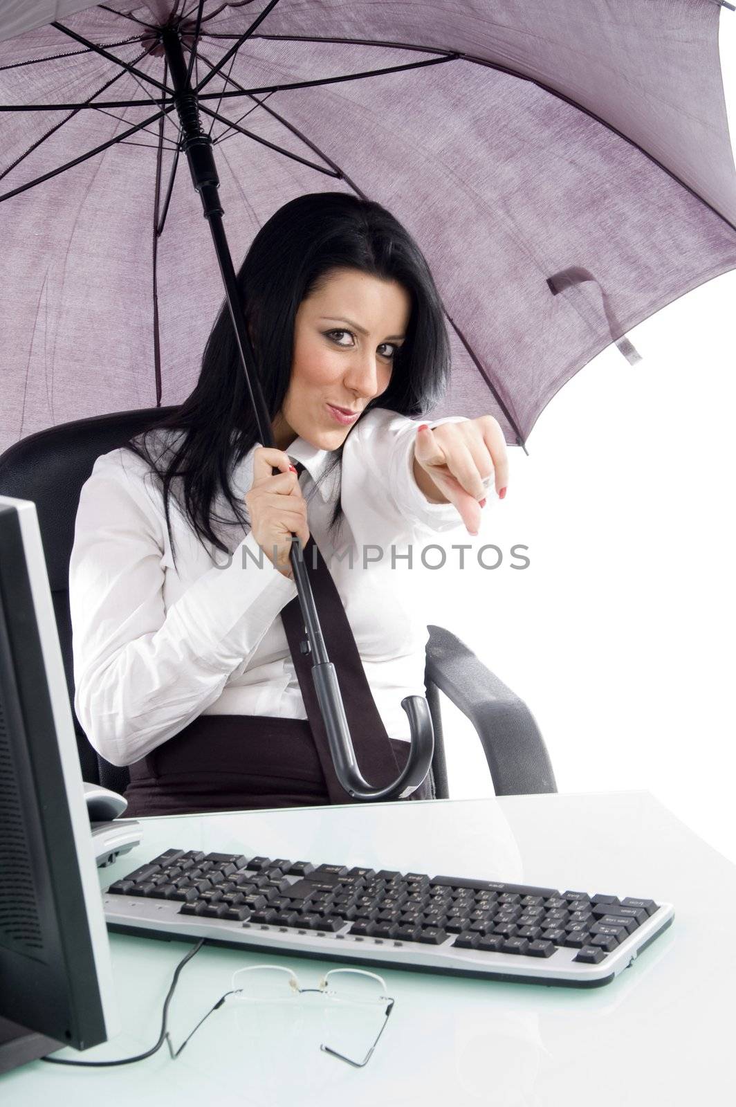 pointing woman with umbrella and computer against white background