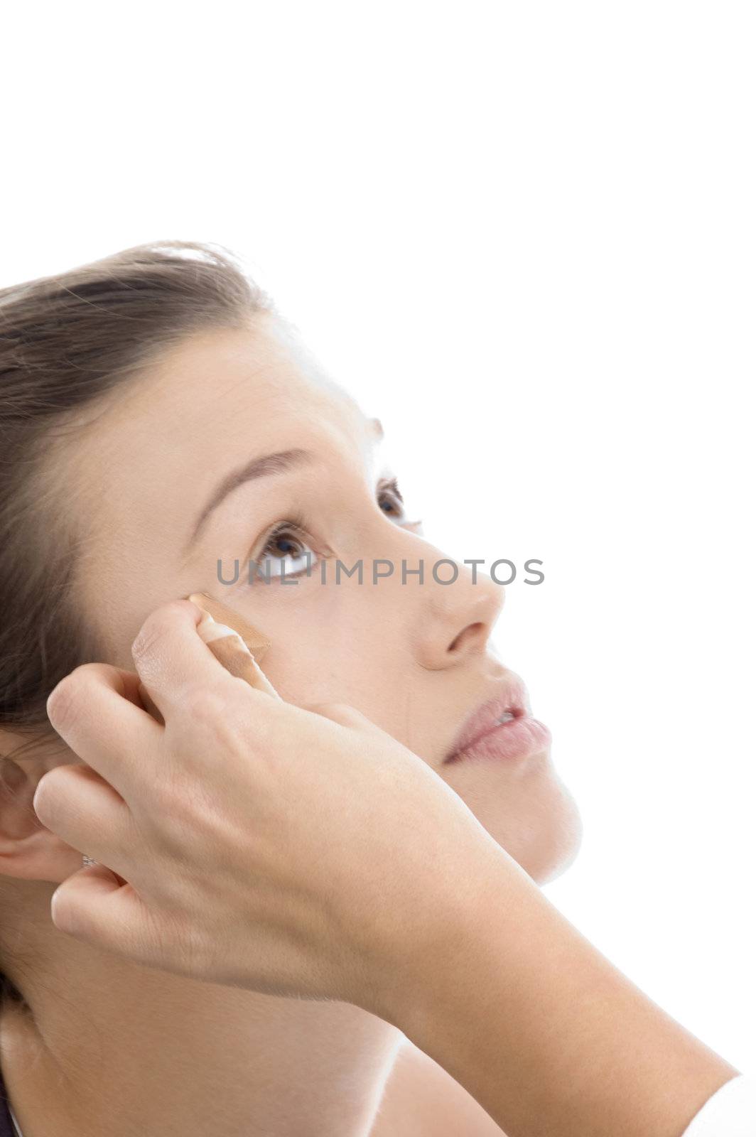 model getting  makeup from beautician on an isolated white background