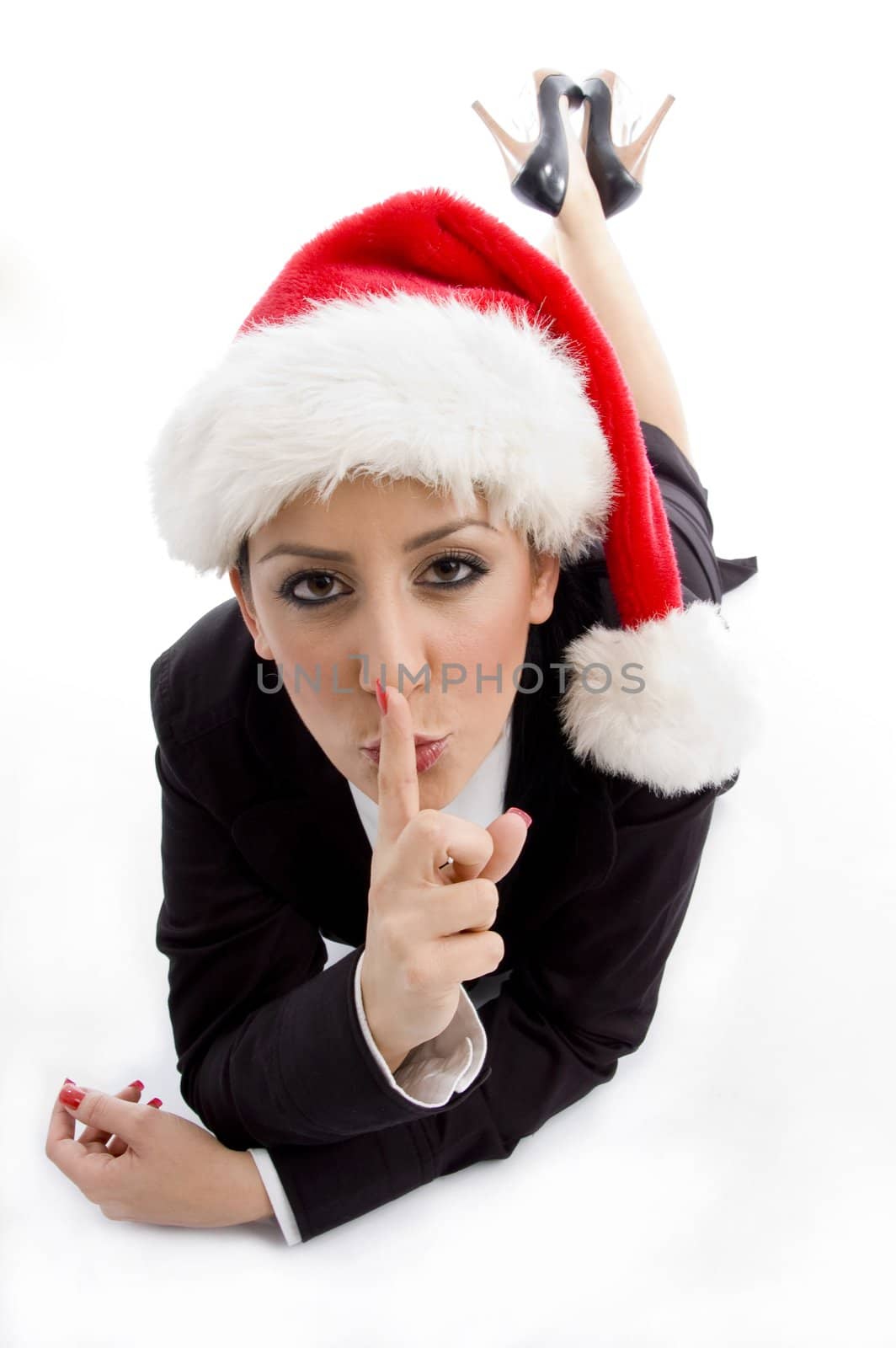businesswoman with christmas hat instructing to keep silent  on an isolated white background