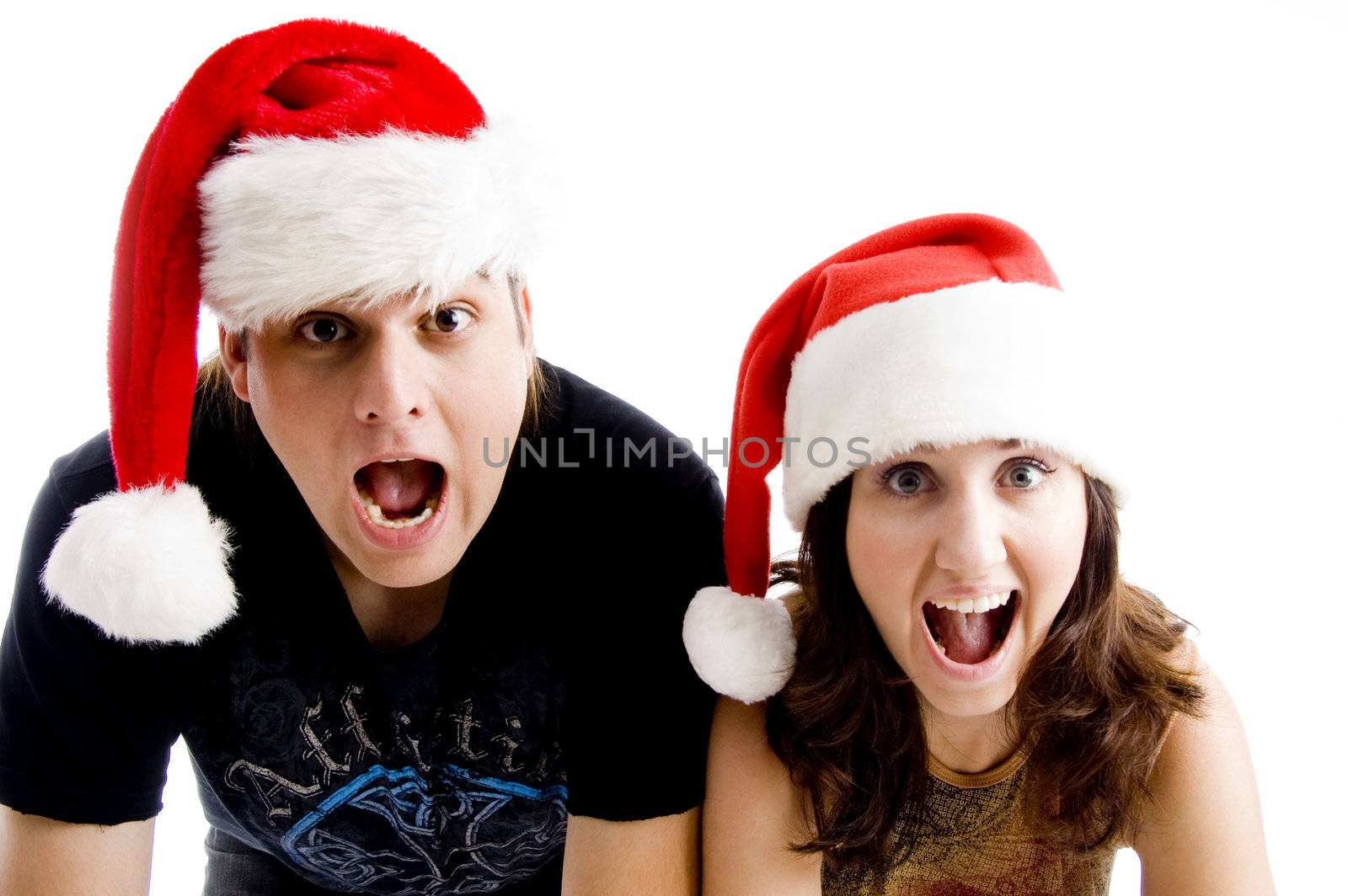 portrait of shouting couple wearing christmas hat on an isolated background