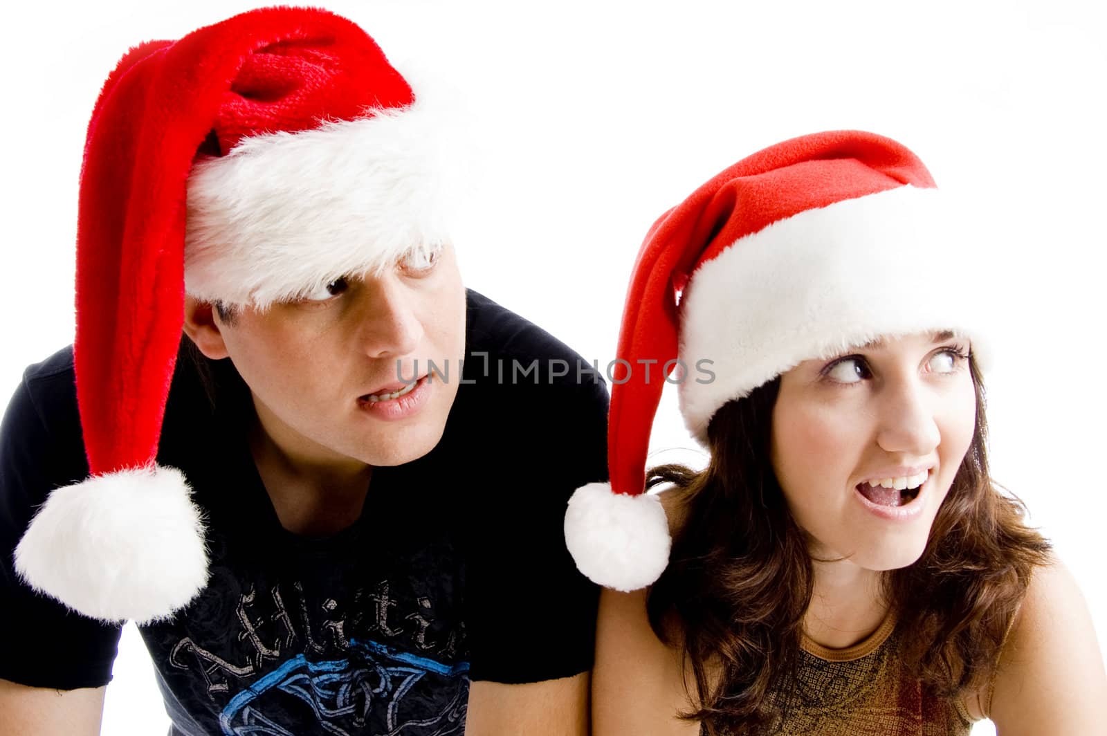 portrait of young couple wearing christmas hat by imagerymajestic