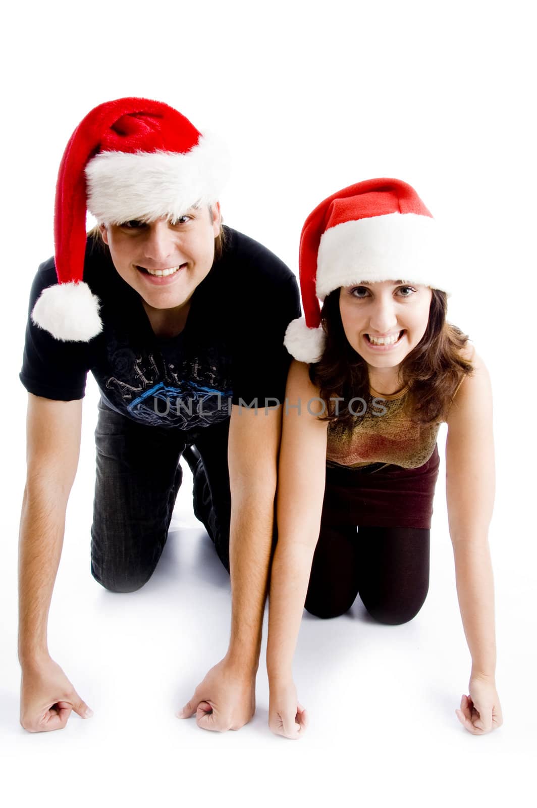 couple with christmas hat and looking at camera against white background