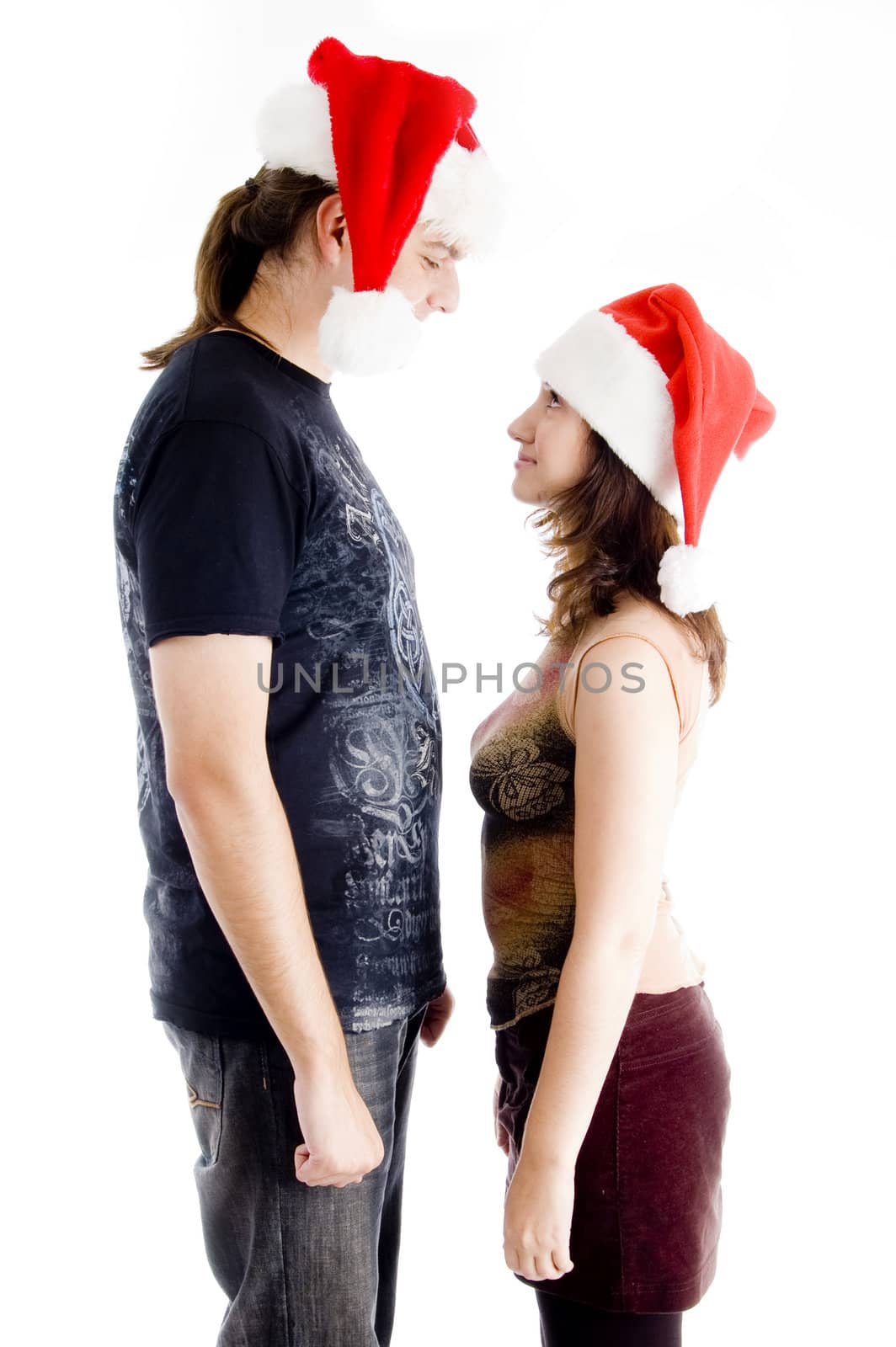 couple with chrisatmas hat and looking to each other on an isolated white background