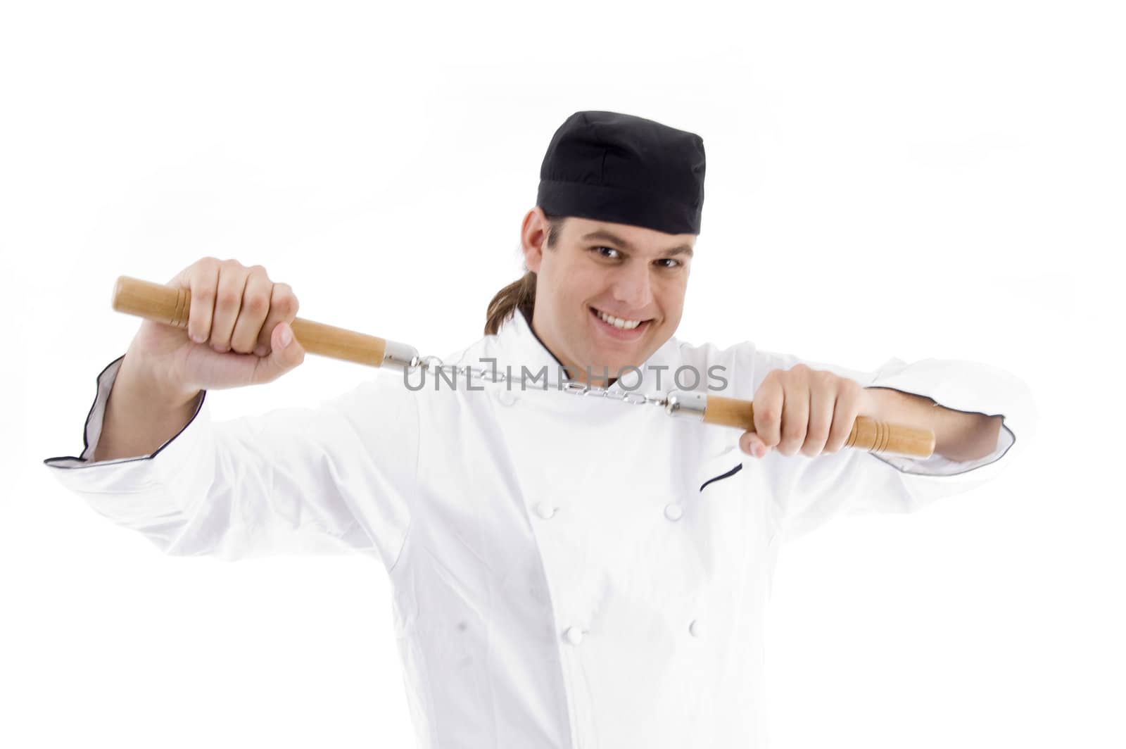 chef posing holding nunchaku on an isolated white background