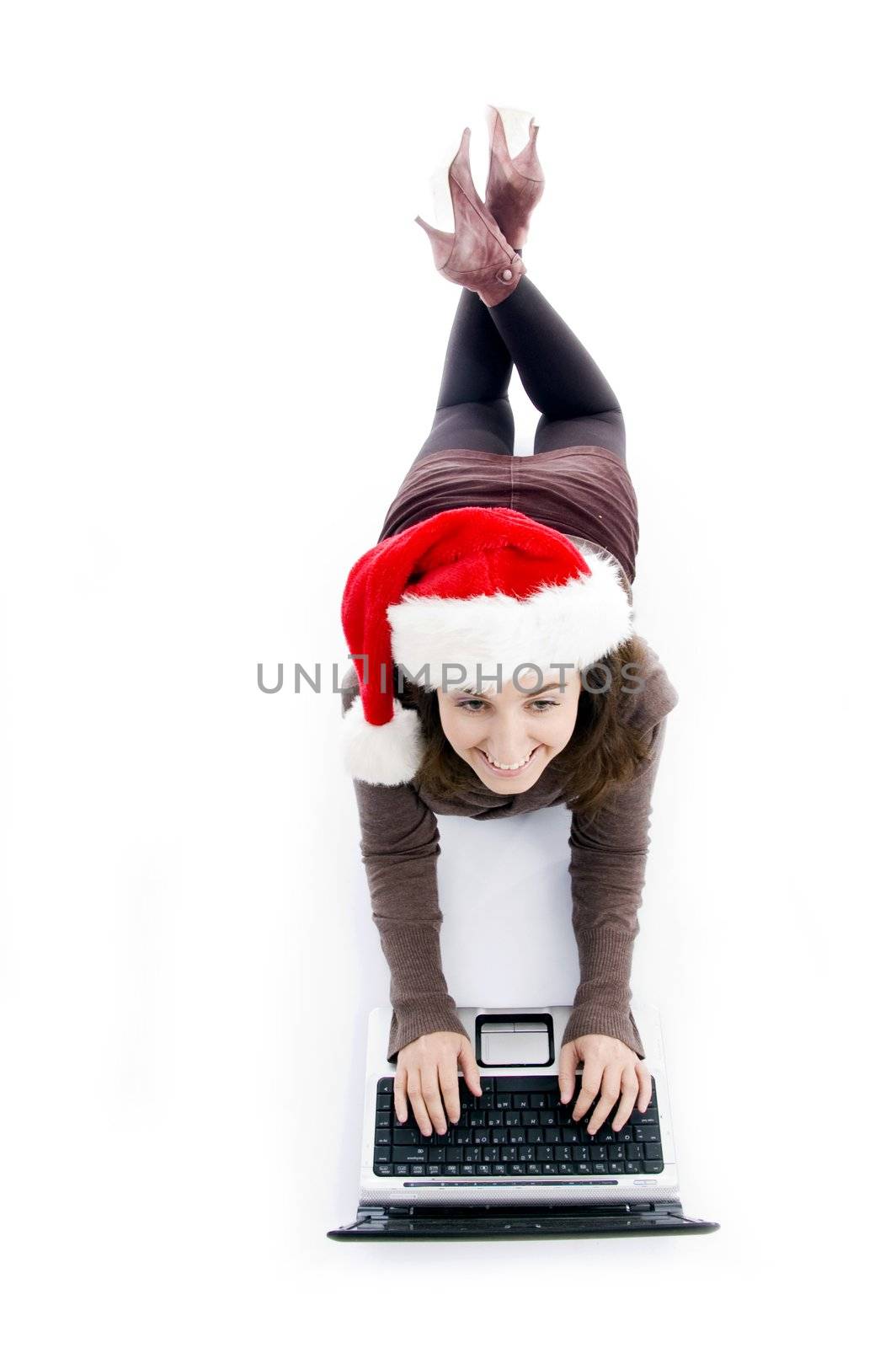 female lying on floor working on laptop against white background