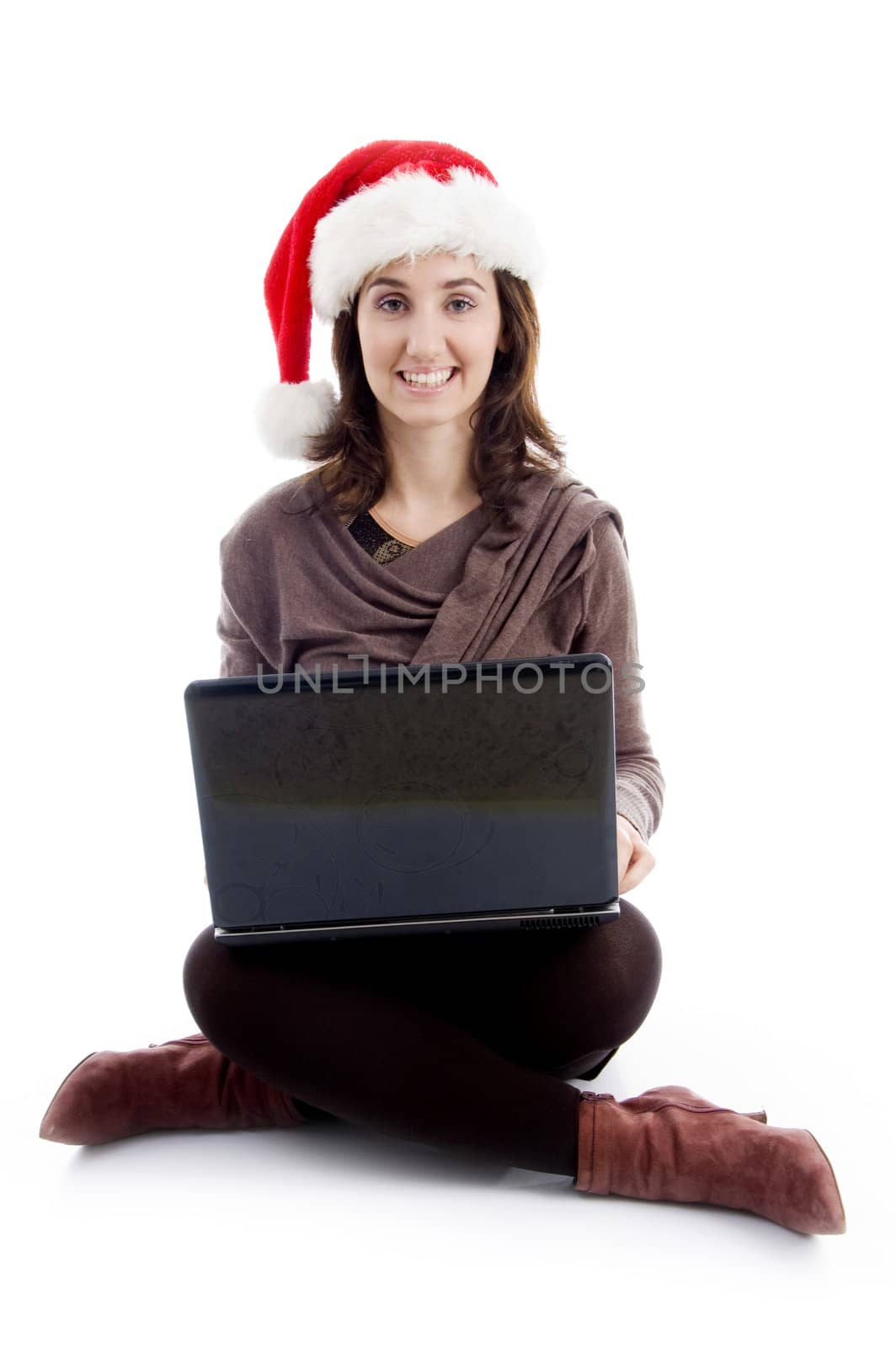 cheerful young woman in christmas hat posing with laptop on an isolated white background