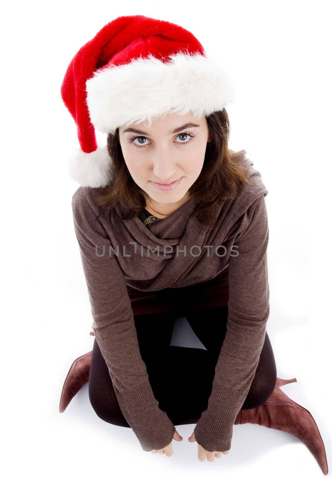 female in christmas hat sitting on floor isolated on white background