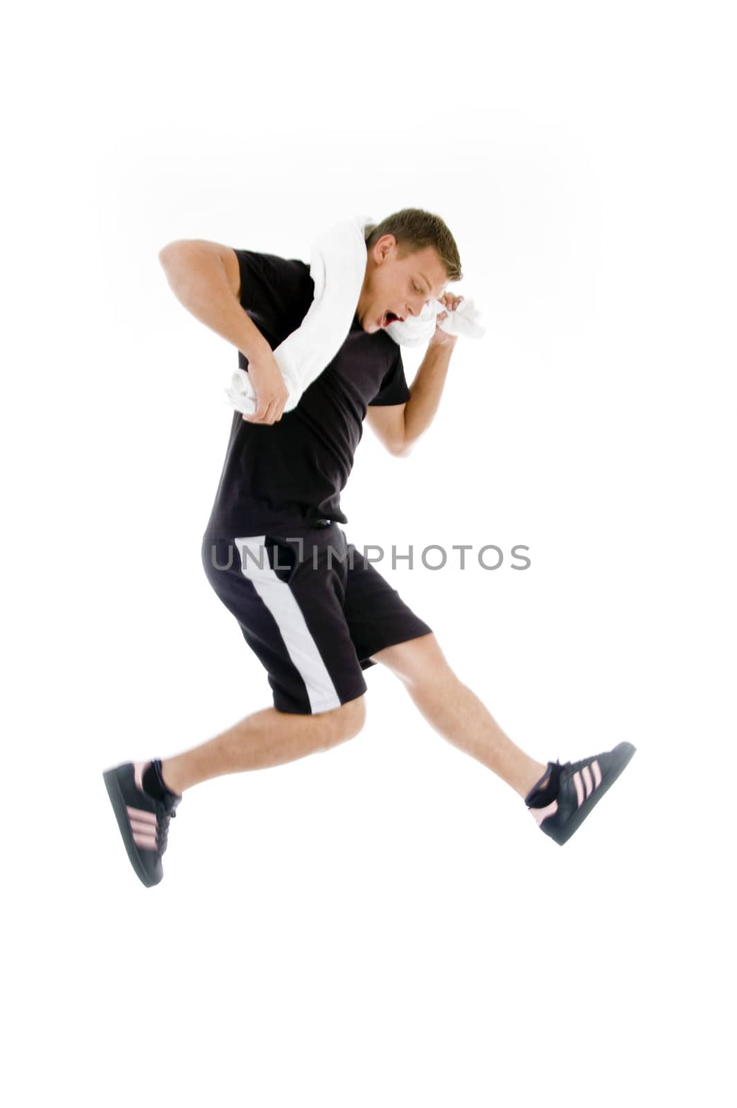 young man with towel around his neck and jumping high on an isolated white background