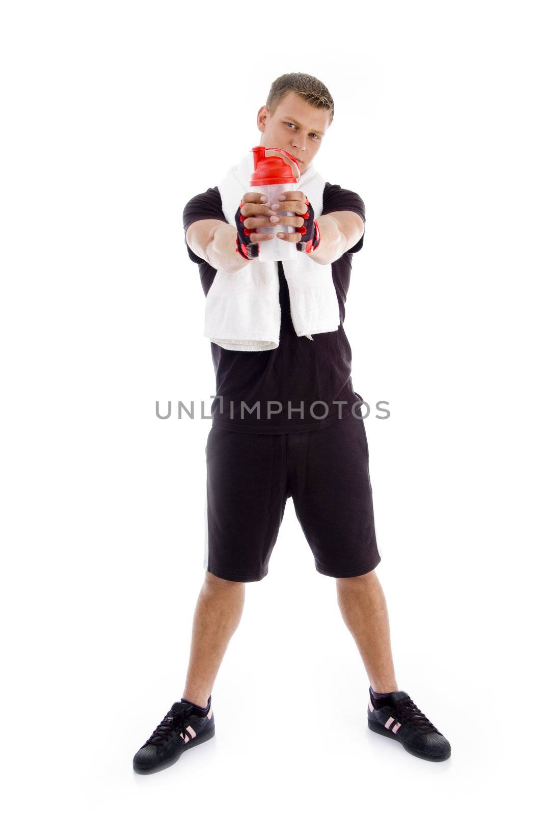 standing muscular male holding a water bottle on an isolated background