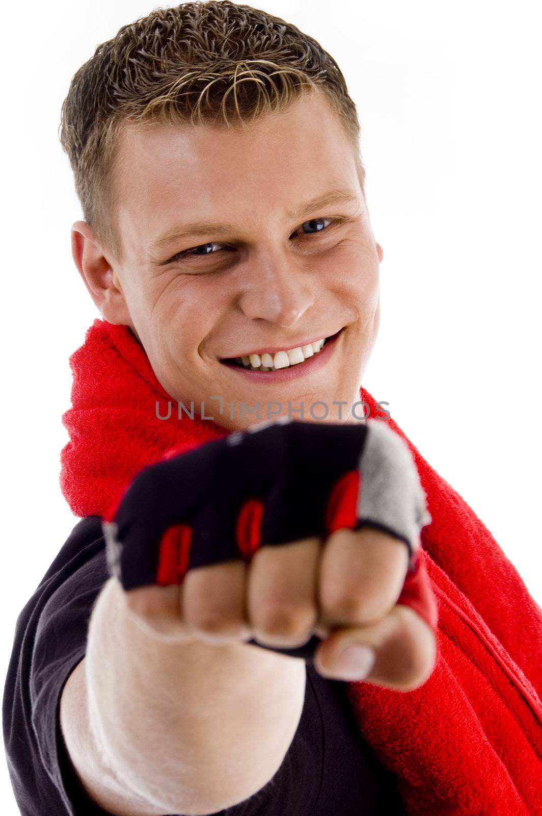 smiling muscular male with towel showing punch on an isolated white background