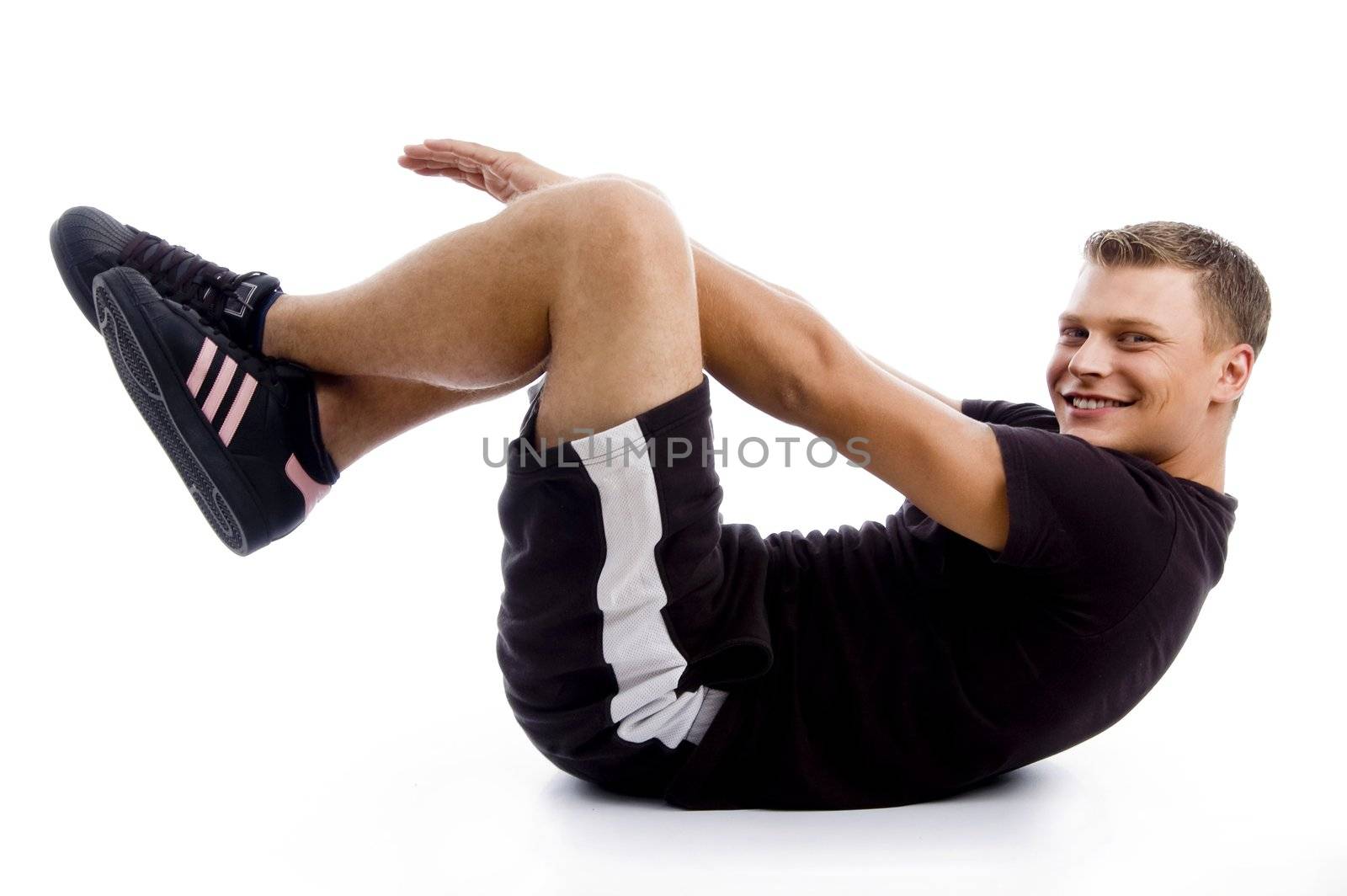 handsome muscular guy doing crunches against white background