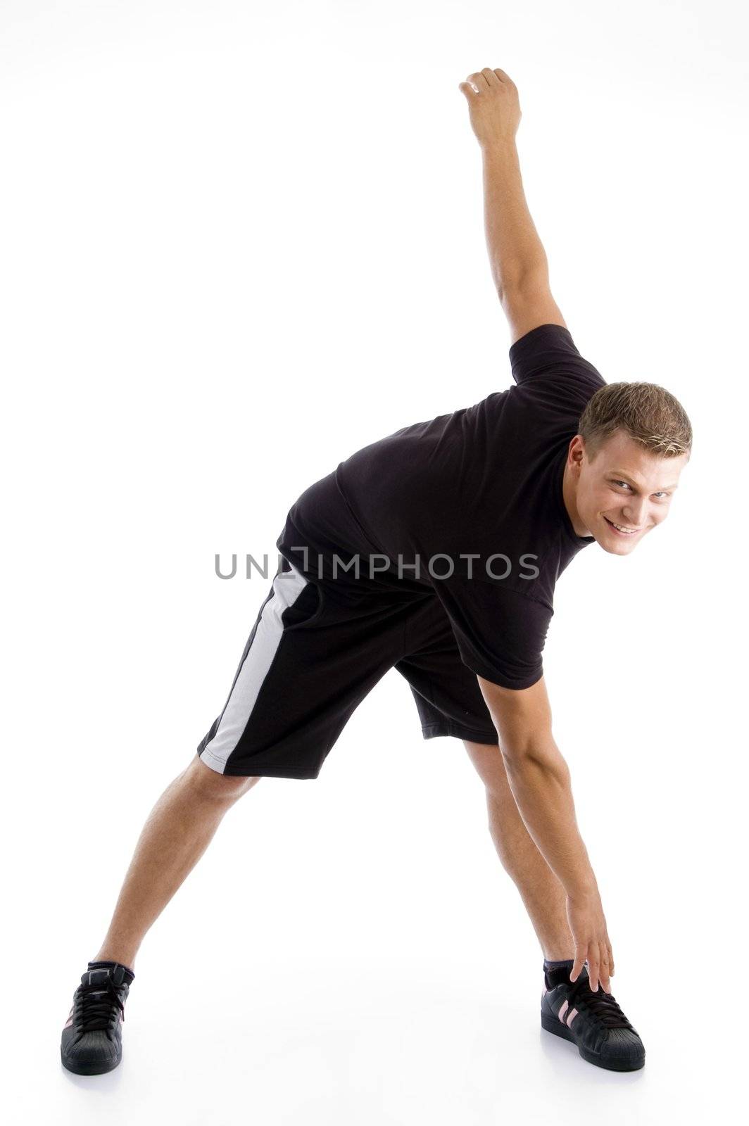 handsome muscular guy doing exercise on an isolated background