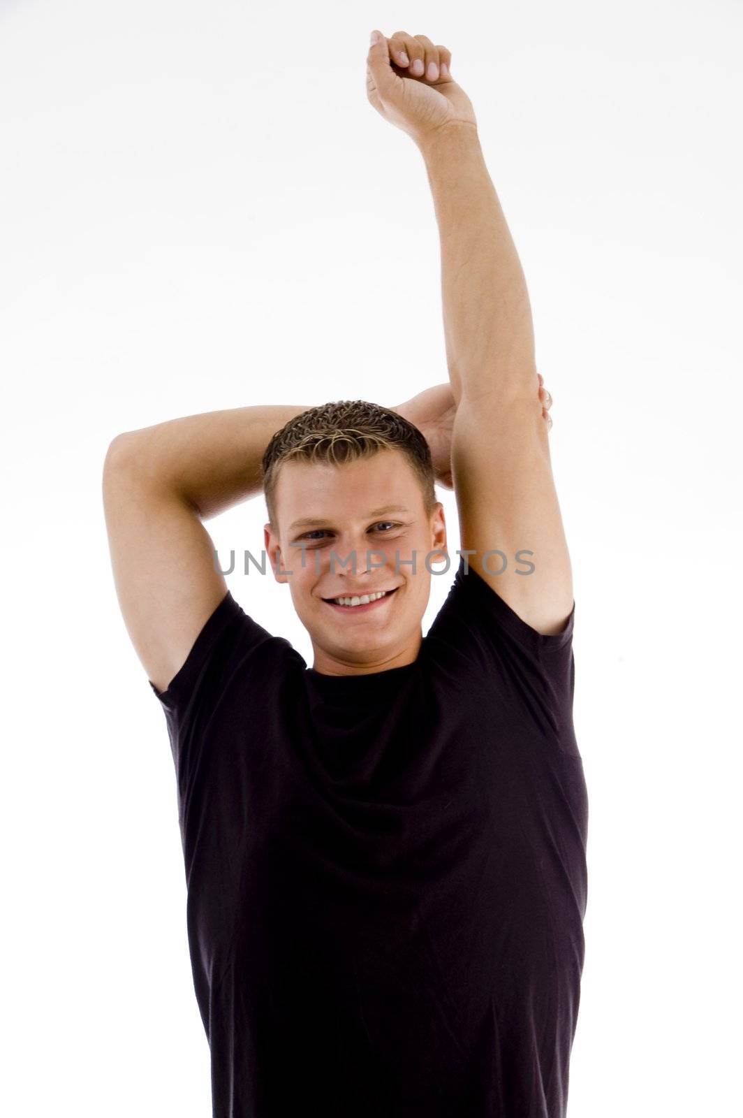 handsome muscular man stretching his arms against white background