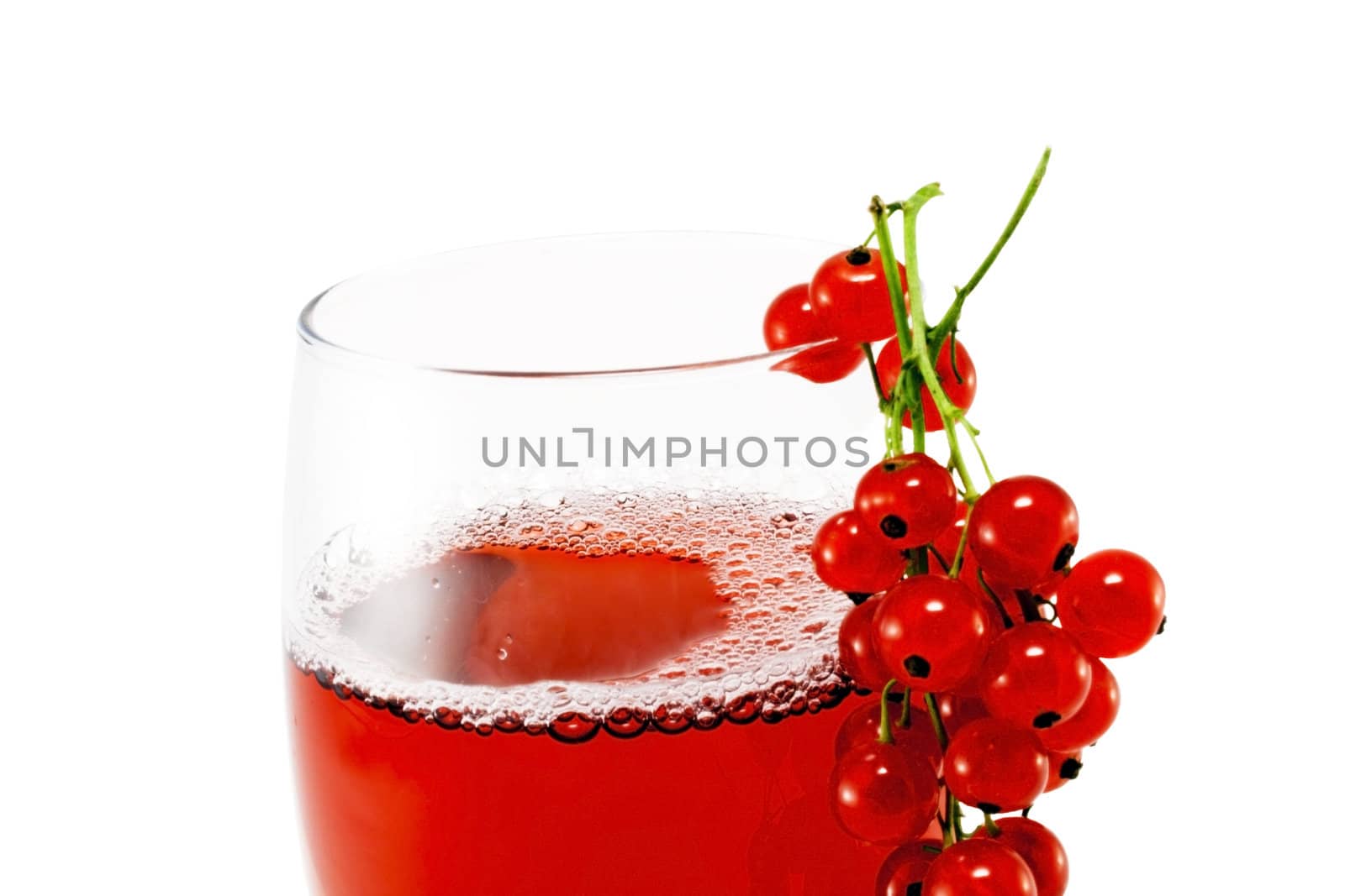 Glass cup with red currant juice isolated on white