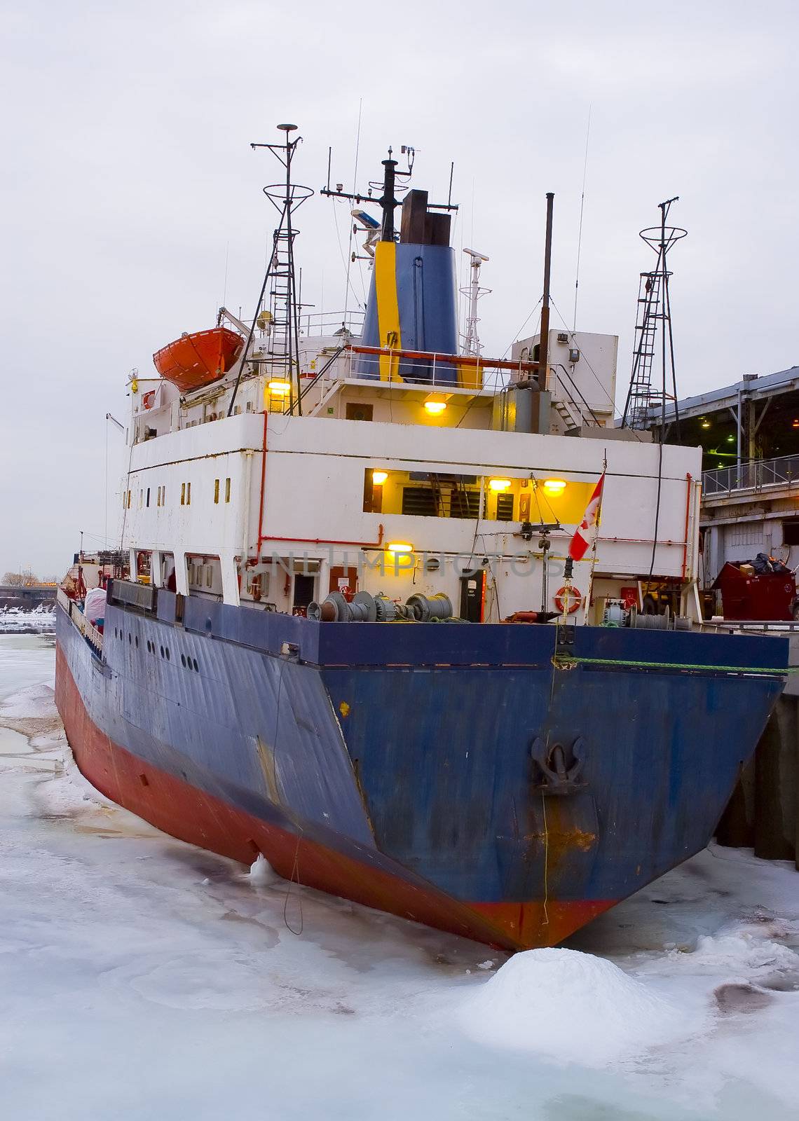 a rusty cargo ship prisoner of ice