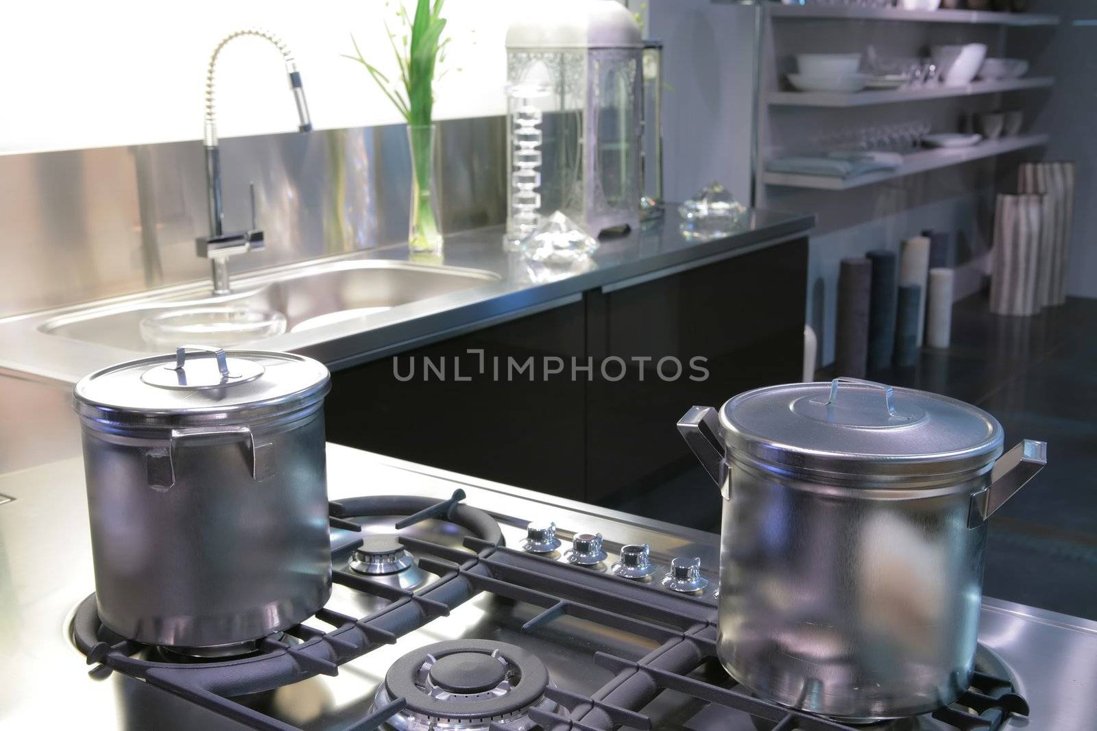 fragment of the interior modern kitchen with gas fryer and saucepan