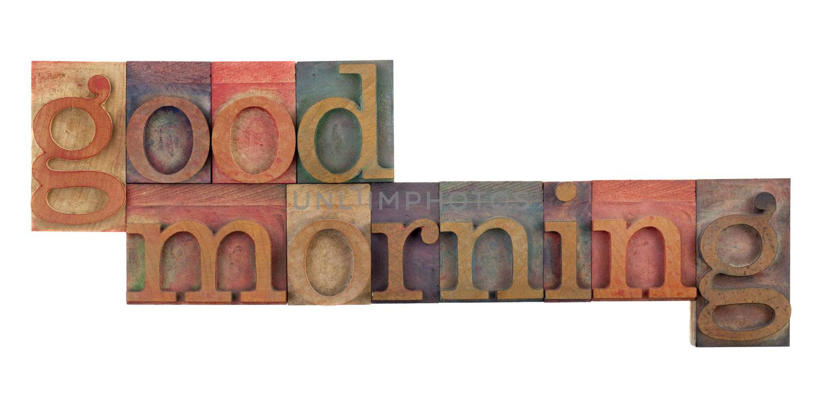 good morning greeting in vintage wood letterpress type blocks, stained by color ink, isolated on white