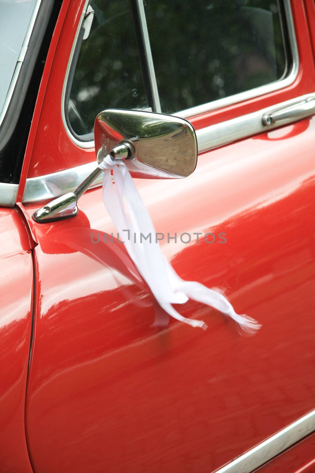 Detail of a vintage French car with wedding decoration by studioportosabbia