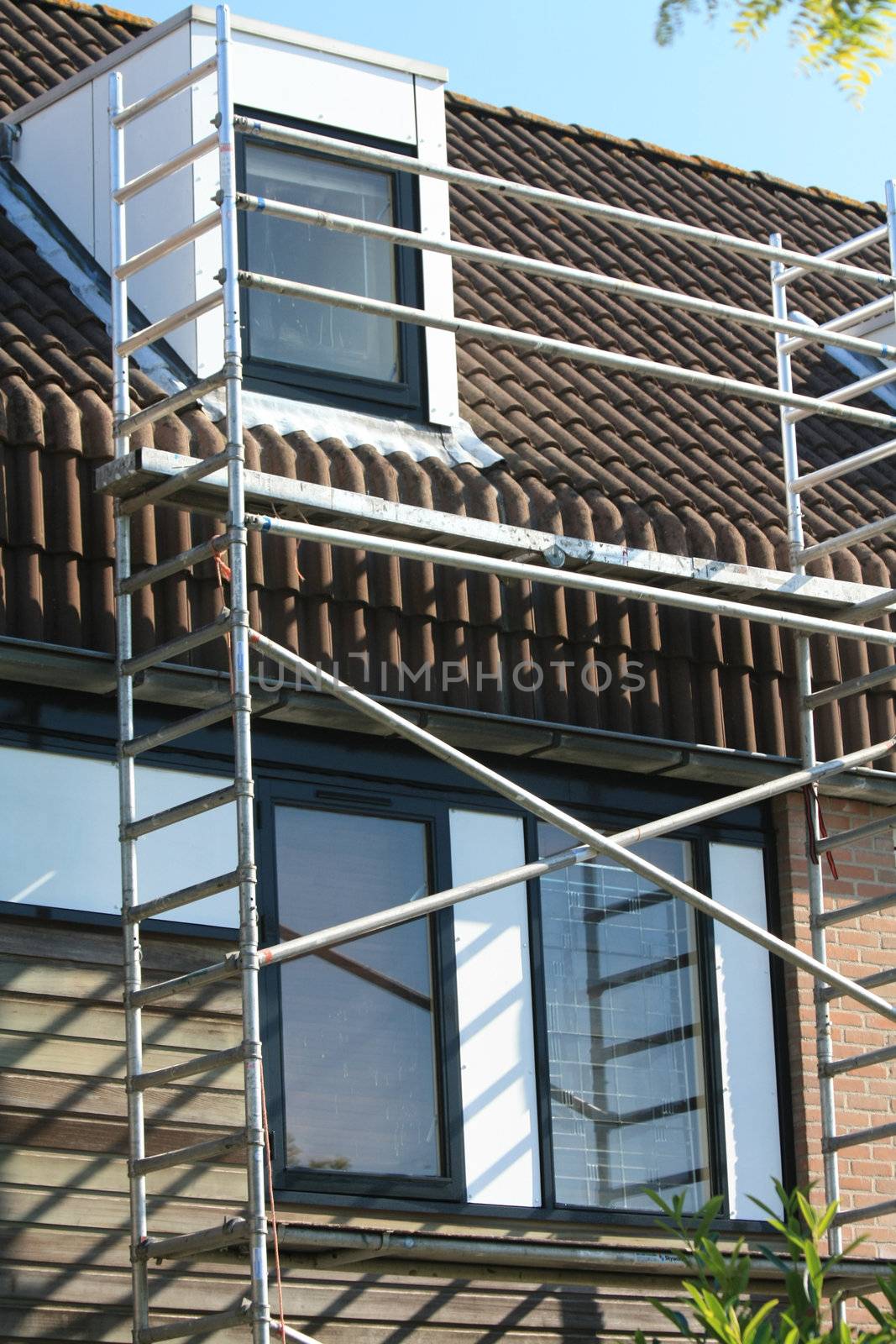 A town house almost covered in scaffolding for maintenance 