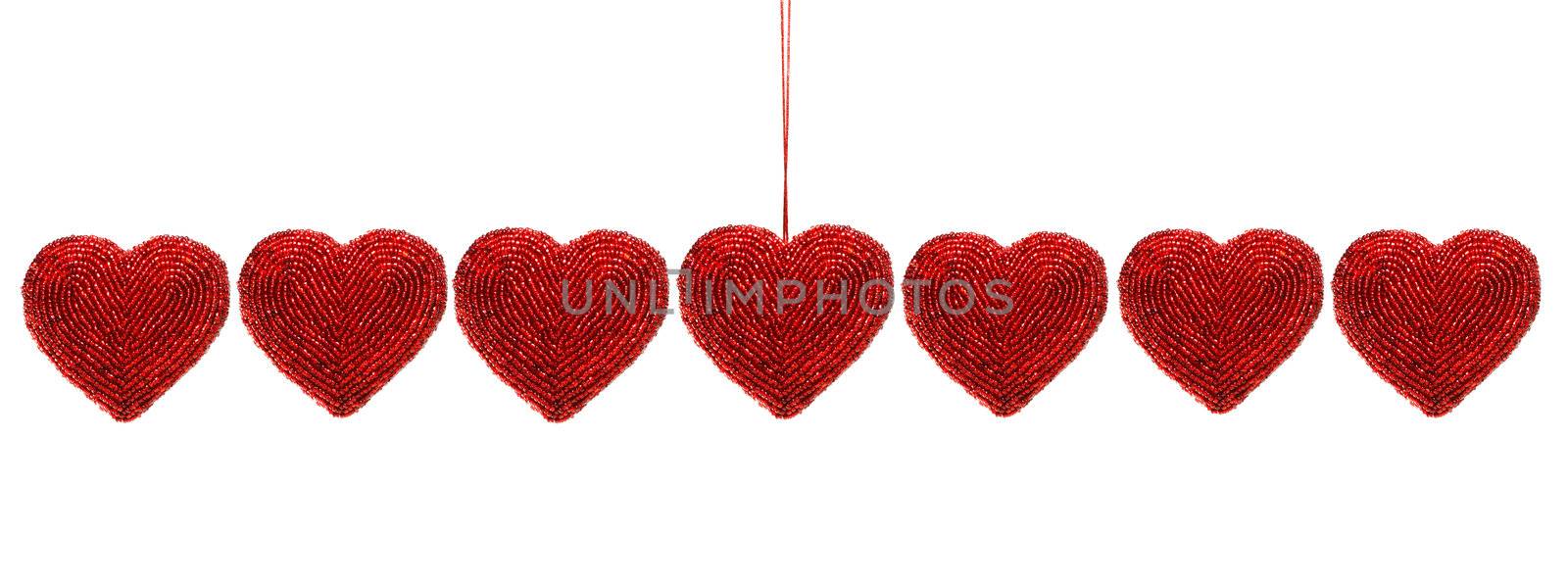 Red beaded hearts isolated against white background