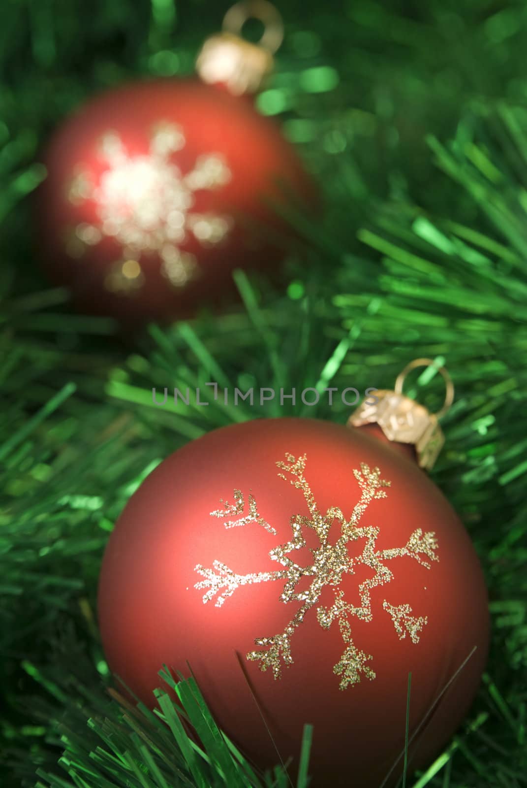 Red christmas balls on the green tinsel. Shallow dof, aRGB.