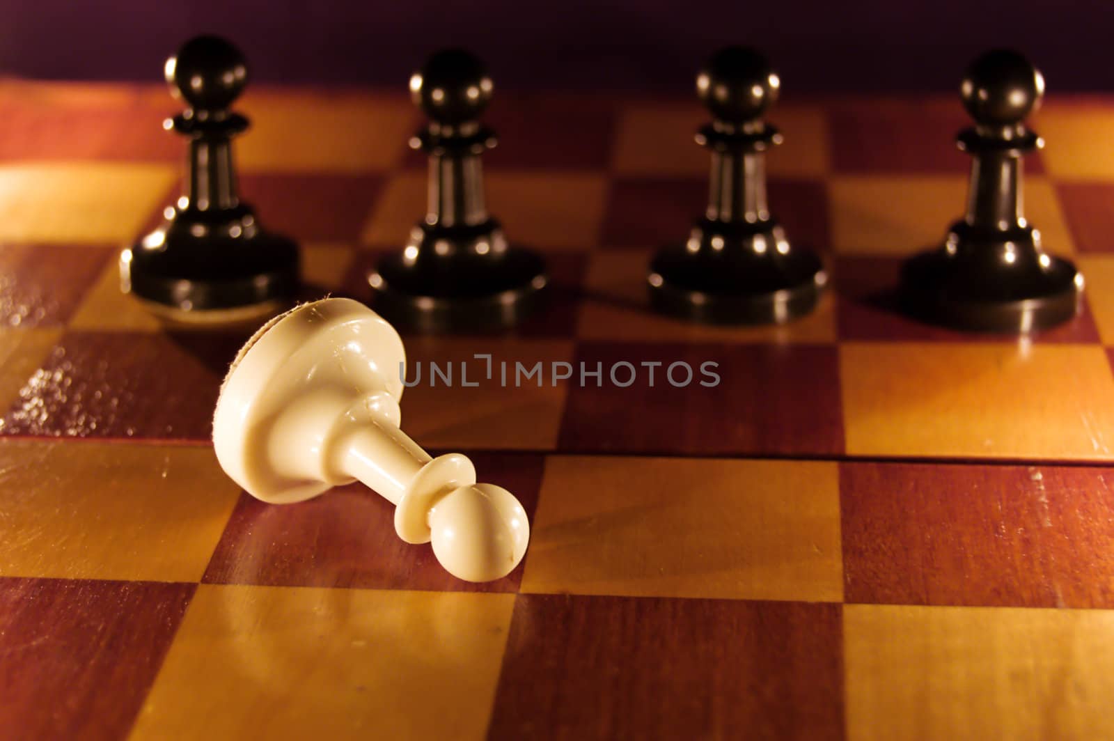 White pawn lying on chess board