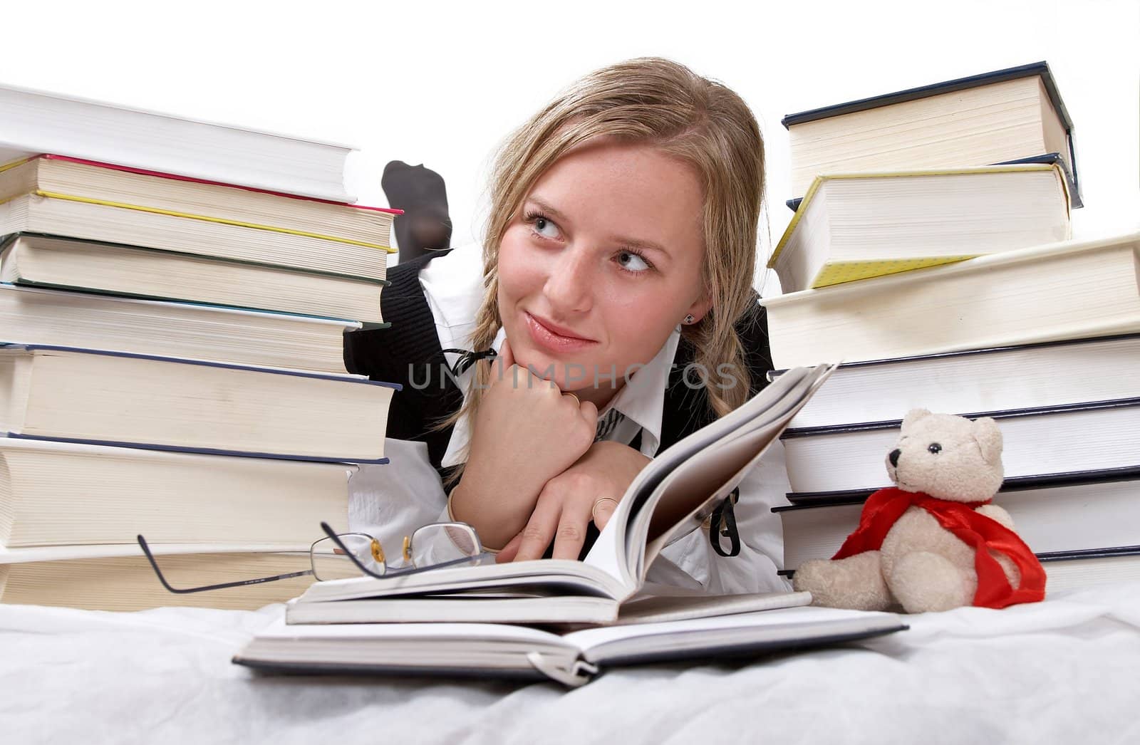 Schoolgirl or student reading books. Interesting books. She is happy. Isolated on white.