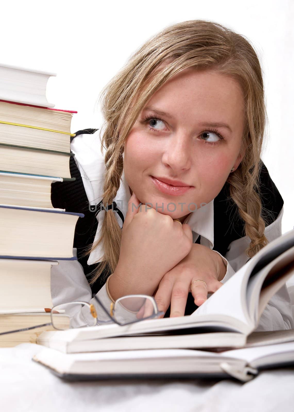 Schoolgirl or student reading books. Interesting books. She is happy. Isolated on white.