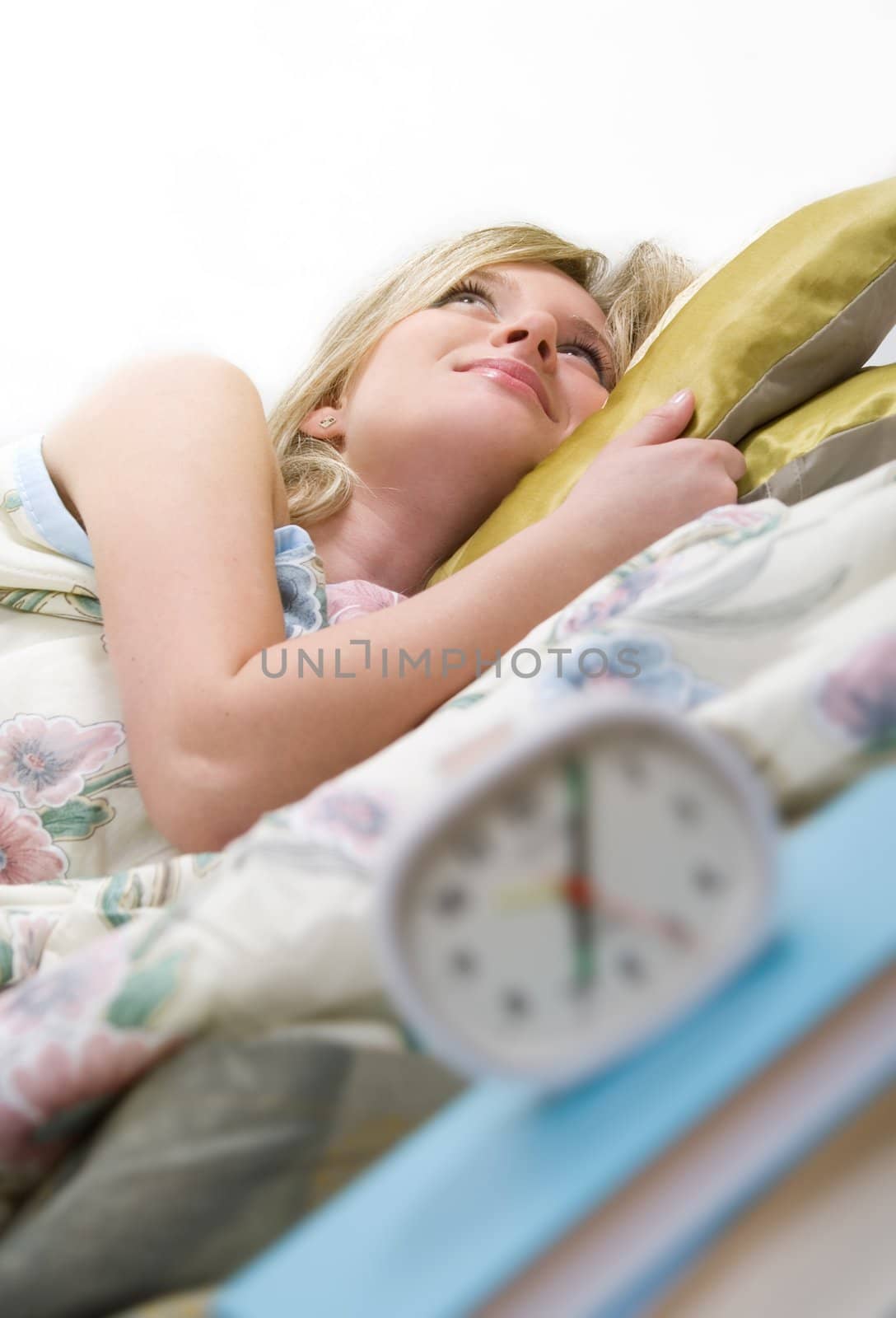 sleepy woman shuts off  alarm clock