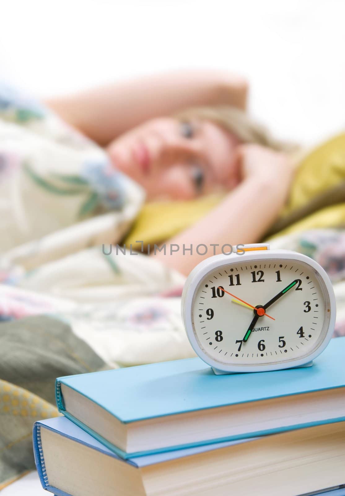 sleepy woman shuts off  alarm clock