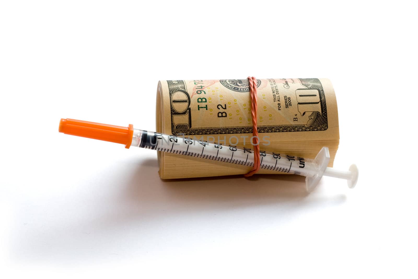 A roll of dollars with syringe isolated on white with clipping path