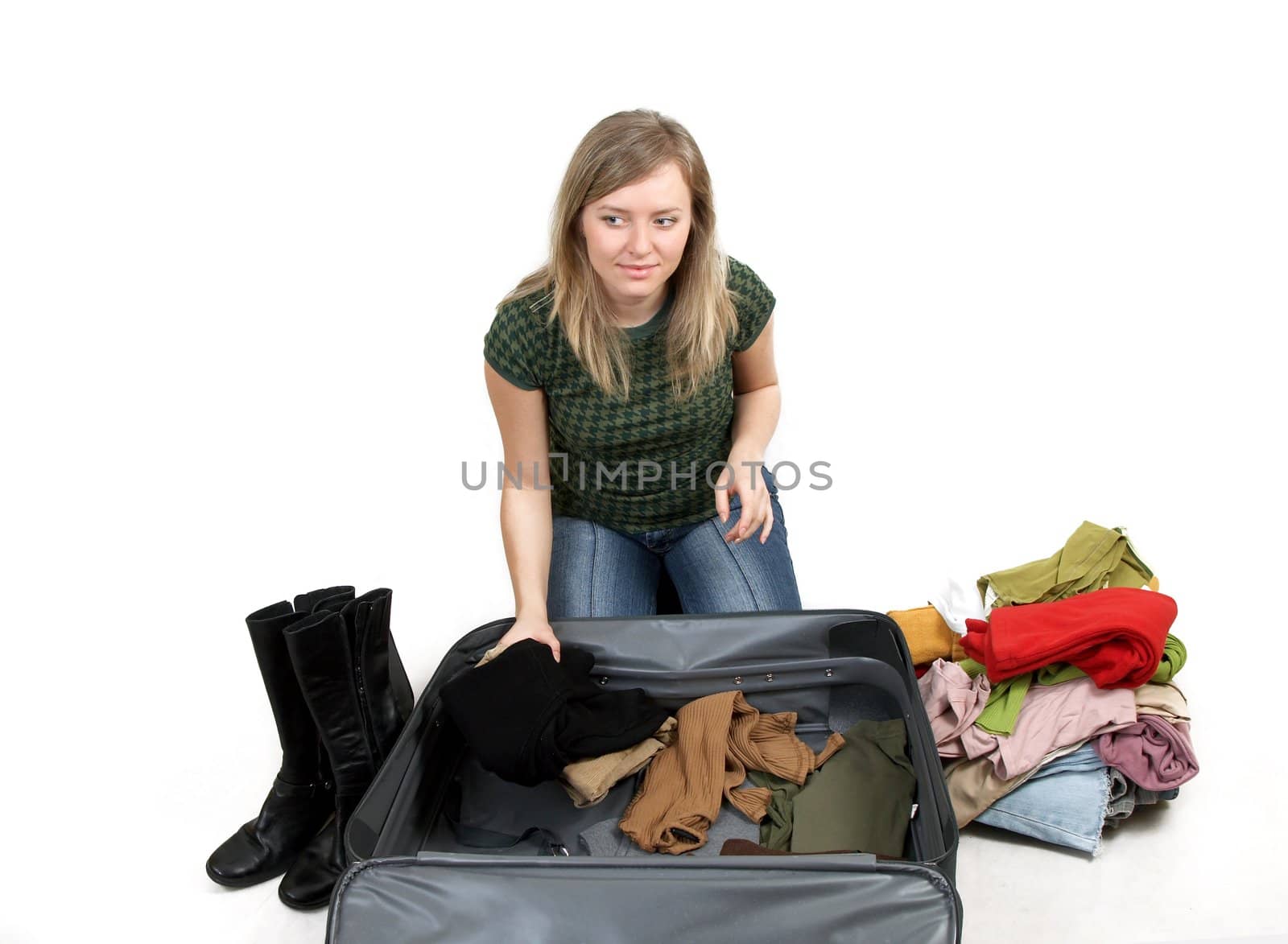 girl is packing clothes by amaxim