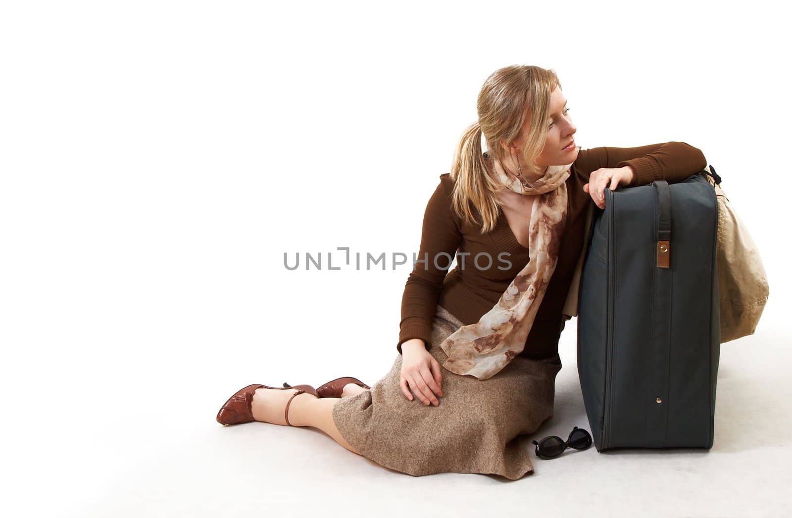 beauty woman with huge bag is sting on station, separate on white