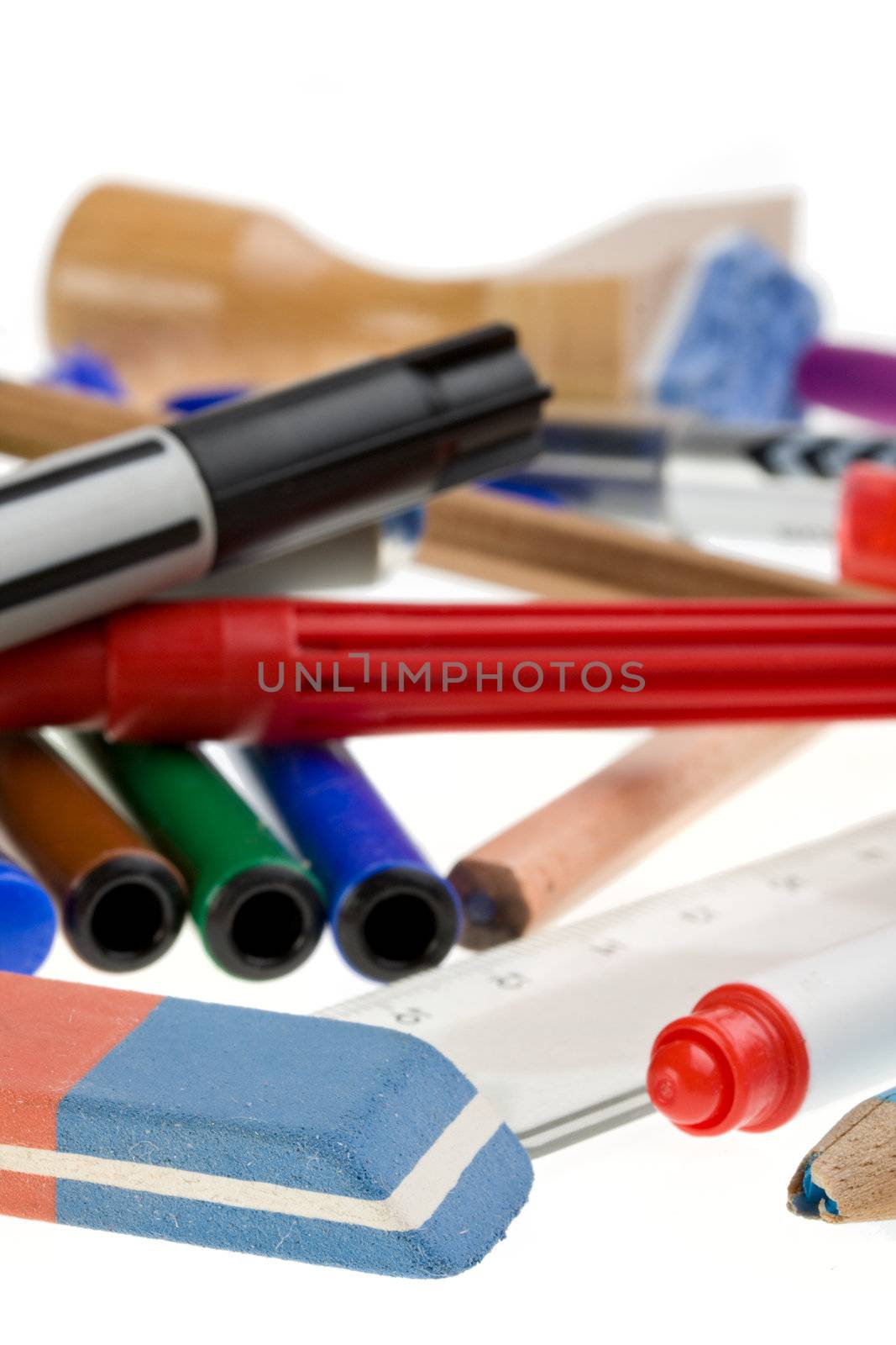 writing utensils, pens and an eraser isolated on white background