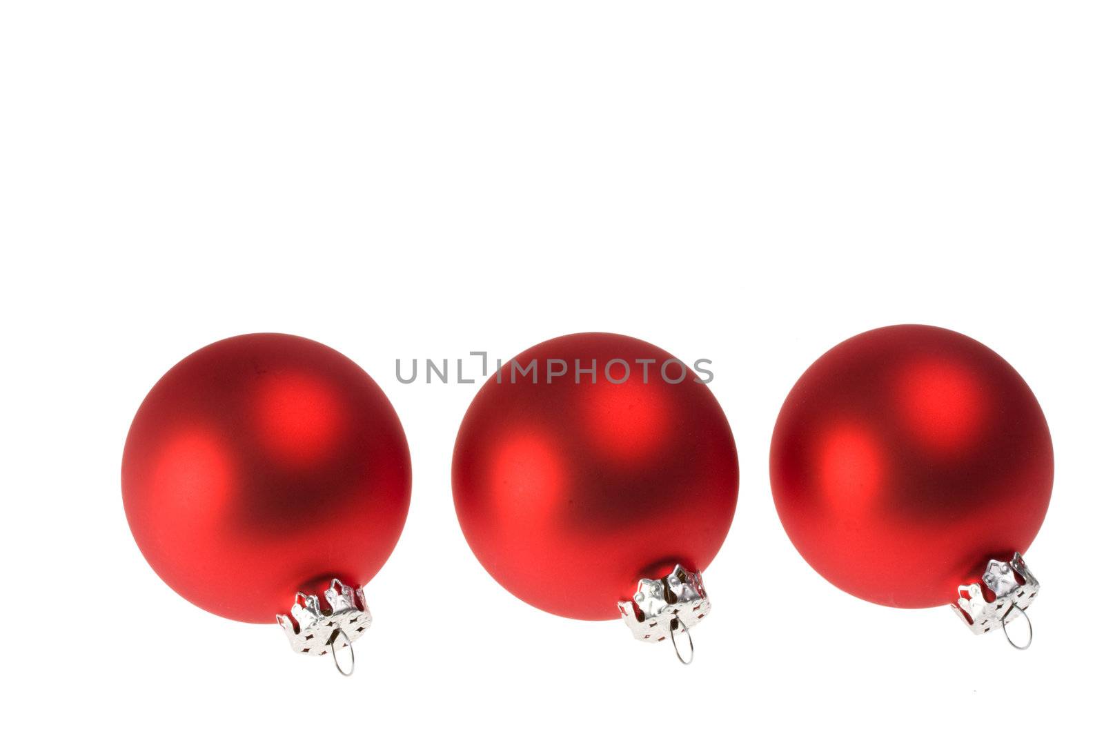 three red christmas baubles isolated on white background