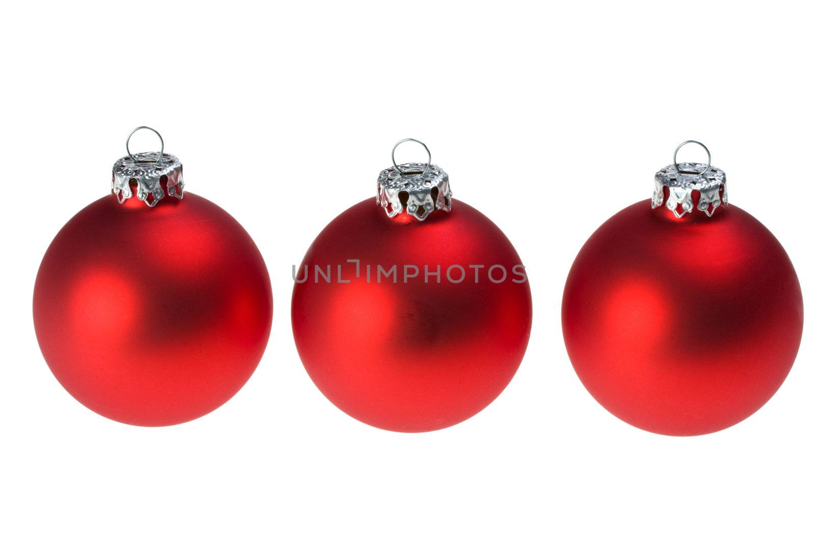 three red christmas baubles isolated on white background