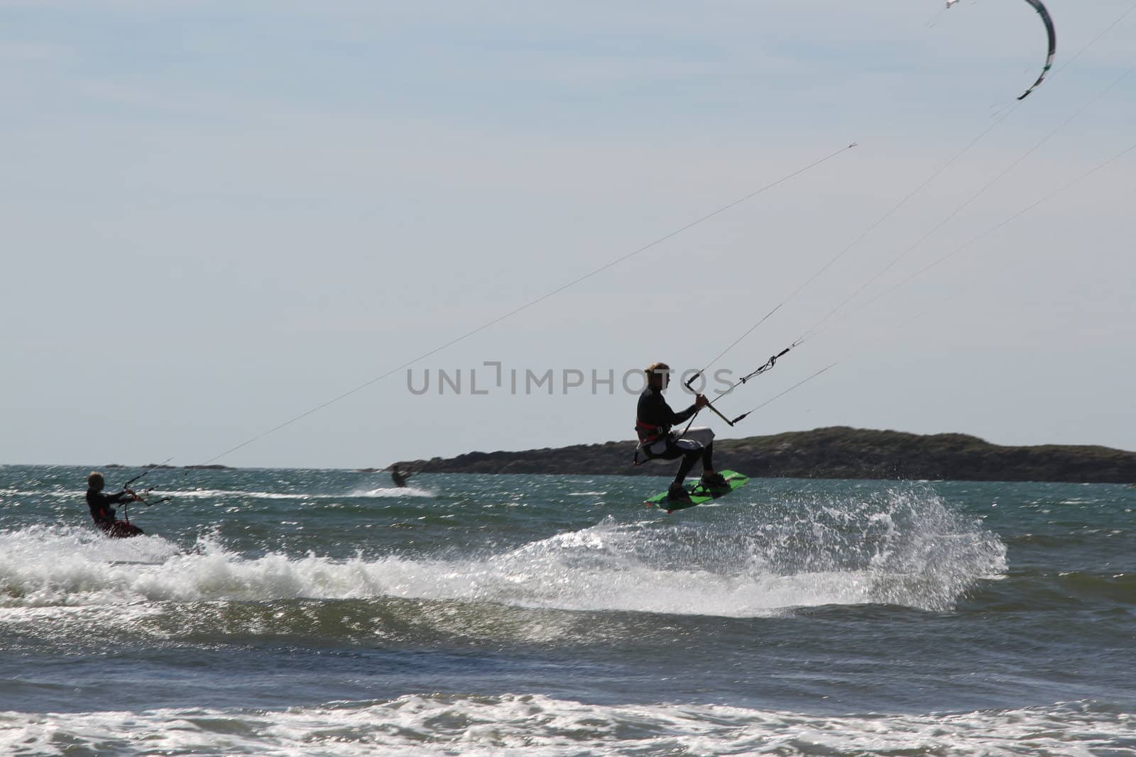 kite surfers in action on a windy day on the sea.