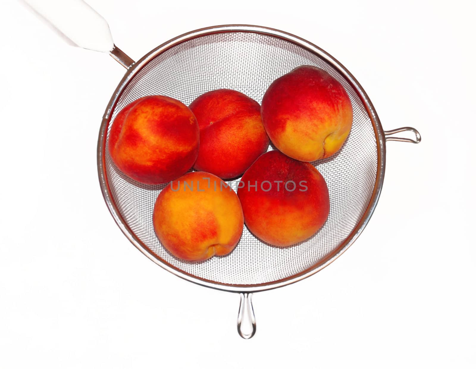 Peaches in colander isolated by simply