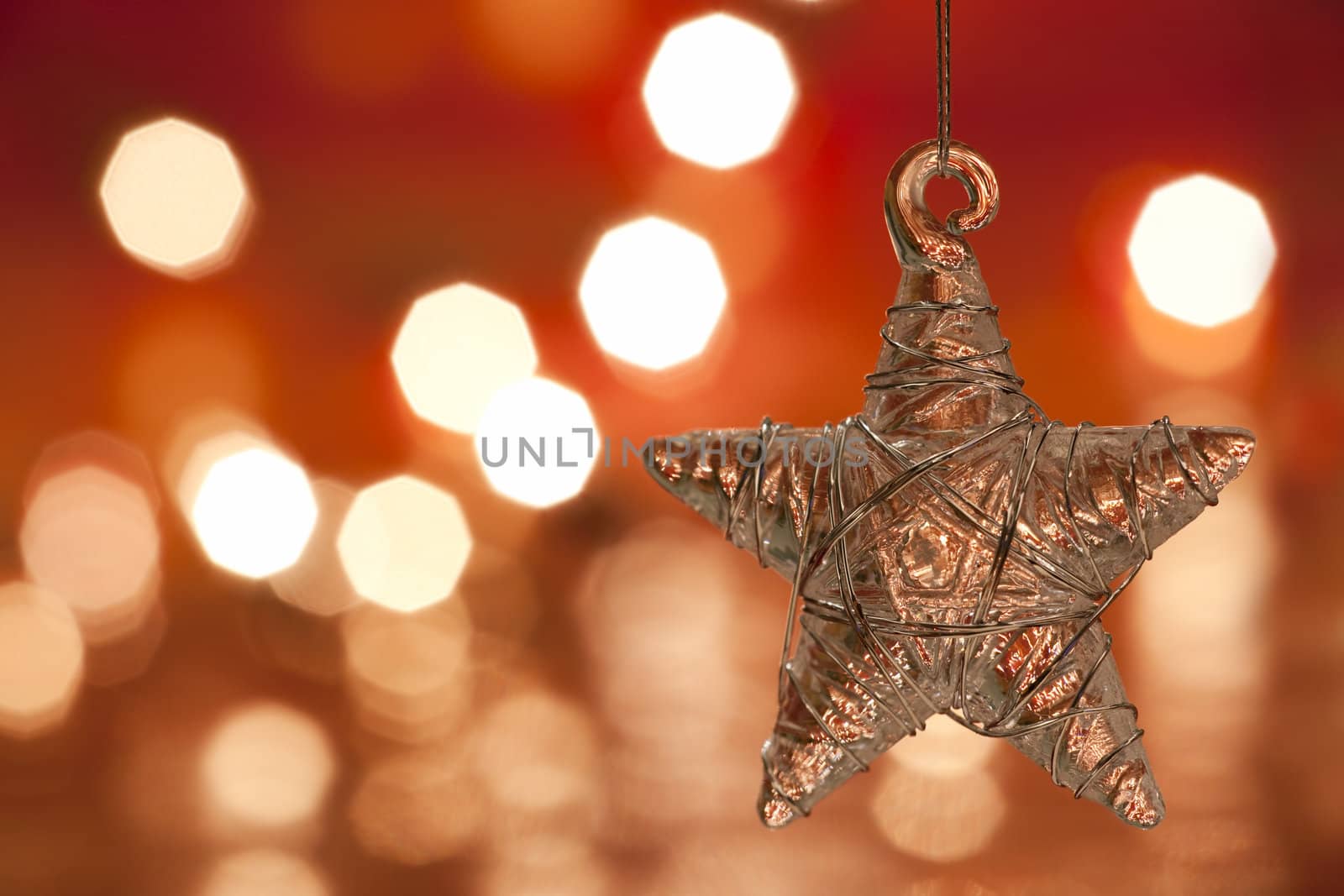 Christmas decoration - glass star. Blurred lights background. aRGB.